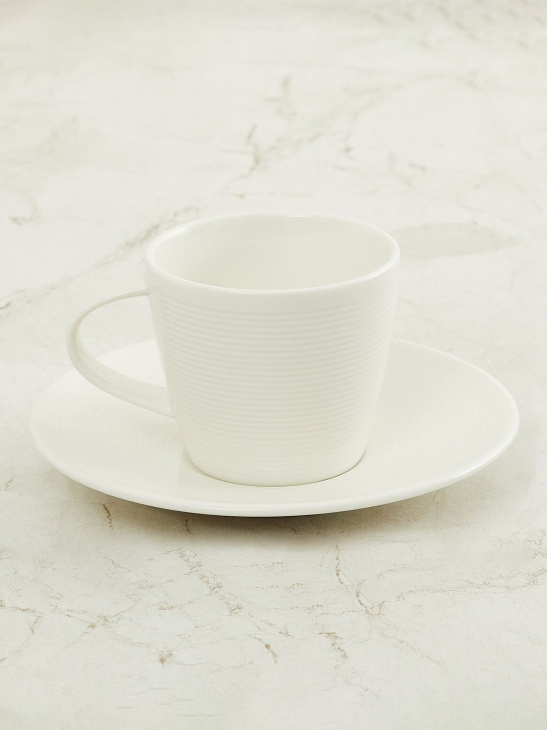 Home Centre White Marshmallow Textured Porcelain Cup And Saucer Price in India