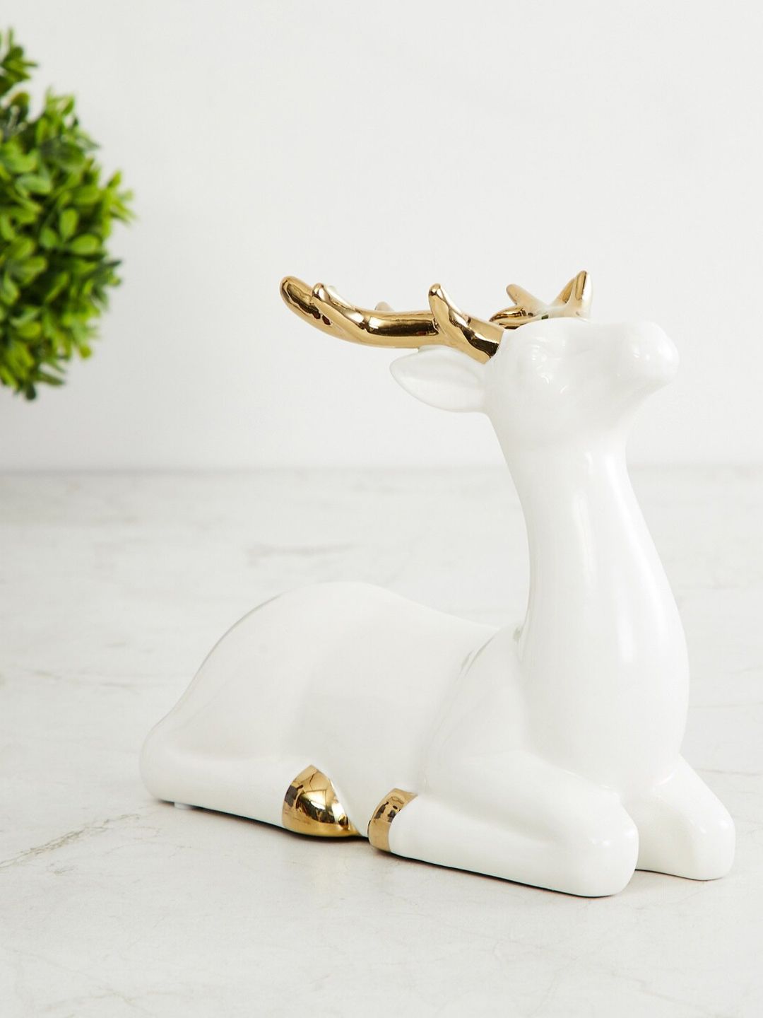 Home Centre White & Gold-Toned Ceramic Brighton Sitting Reindeer Figurine Showpiece Price in India
