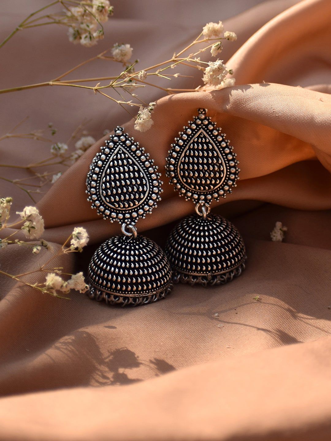 TEEJH Silver-Toned Dome Shaped Oxidised Jhumkas Earrings Price in India