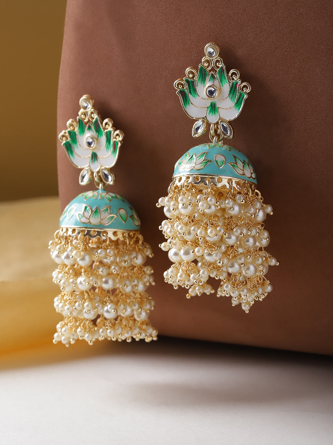Melani Borsa Blue & Off-White Gold-Plated Meenakari Hand Painted Dome Shaped Jhumkas
Melani Borsa Blue & Off-White Gold-Plated Meenakari Hand Painted Dome Shaped Jhumkas