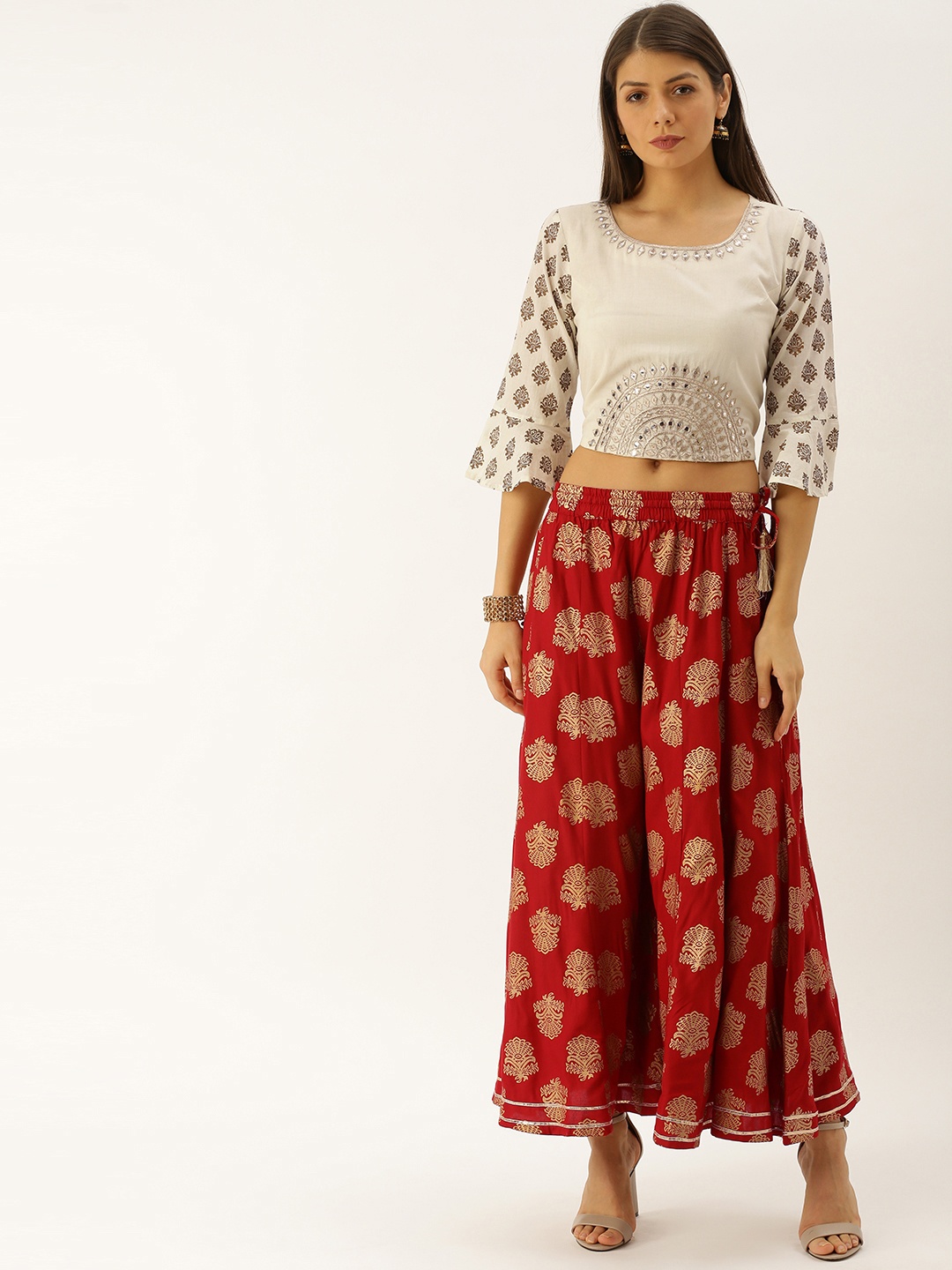 Varanga Women Off-White & Maroon Embroidered Crop Top with Printed Flared Palazzos
Varanga Women Off-White & Maroon Embroidered Crop Top with Printed Flared Palazzos
