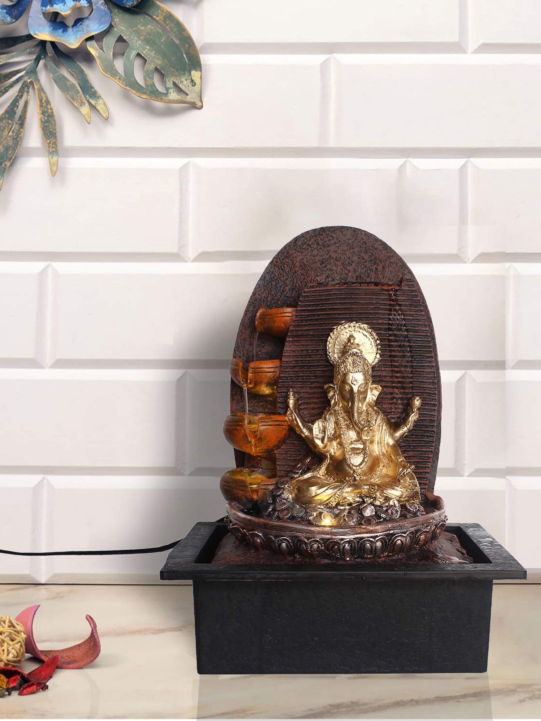 eCraftIndia Gold-Toned & Brown Ganesha 5 Step Polyresin Water Fountain With Led Lights
eCraftIndia Gold-Toned & Brown Ganesha 5 Step Polyresin Water Fountain With Led Lights