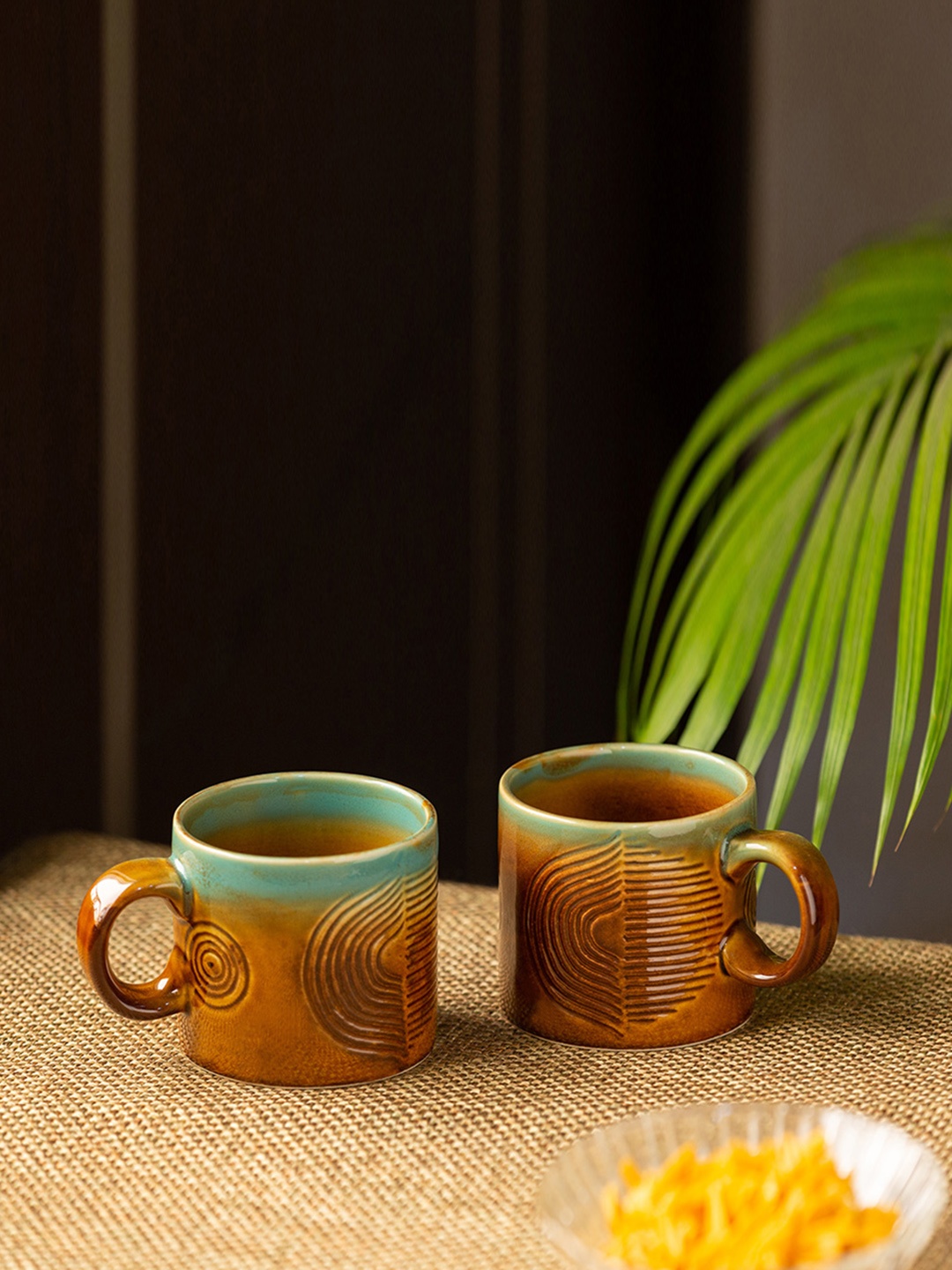 ExclusiveLane Set of 2 Brown & Sea Green Hand-Engraved Ceramic Coffee Mugs 300 ml Each
ExclusiveLane Set of 2 Brown & Sea Green Hand-Engraved Ceramic Coffee Mugs 300 ml Each