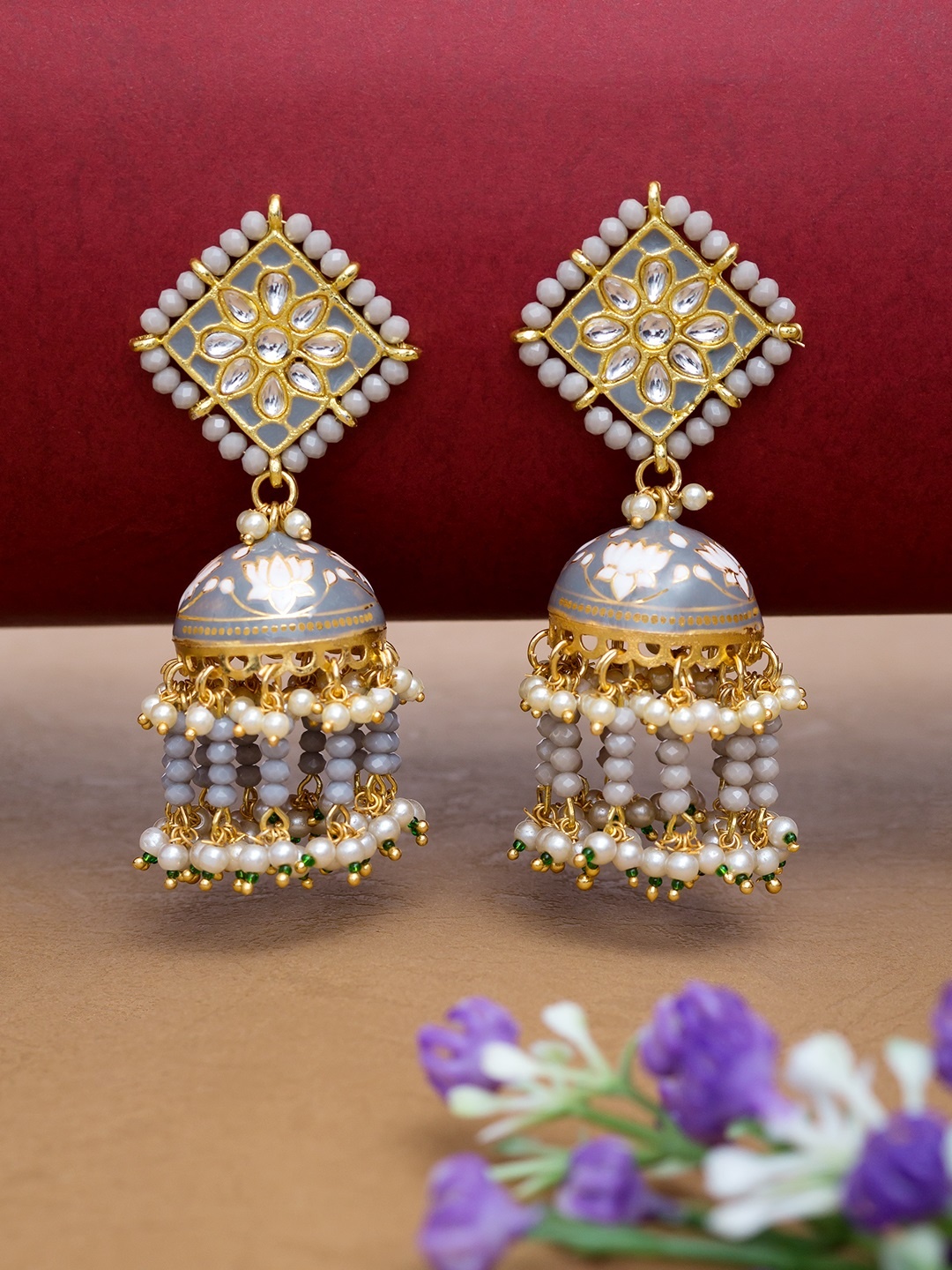 Golden Peacock Grey & Gold-Toned Stone-Studded & Beaded Enamelled Dome Shaped Jhumkas
Golden Peacock Grey & Gold-Toned Stone-Studded & Beaded Enamelled Dome Shaped Jhumkas