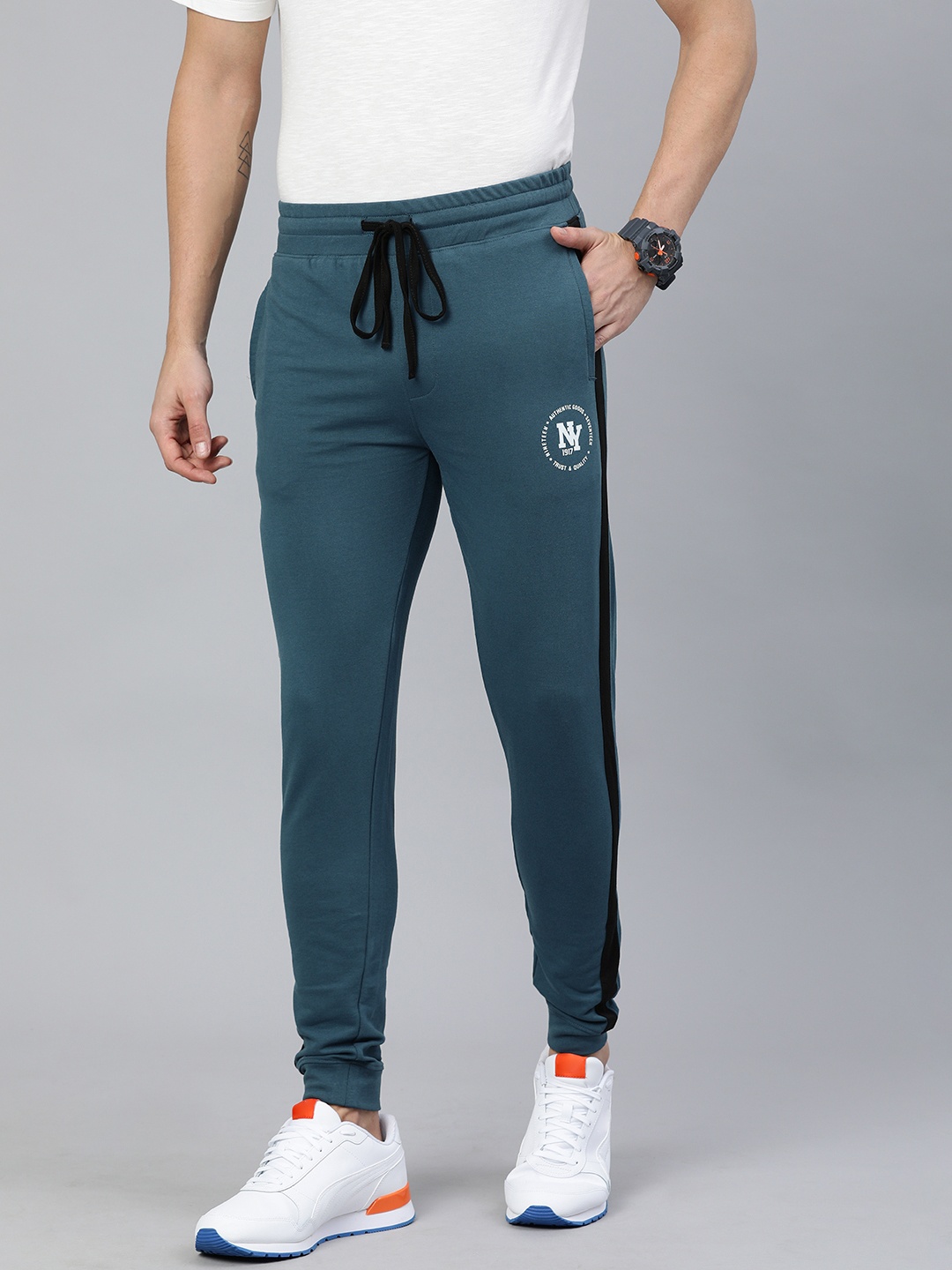 The Indian Garage Co Men Men Teal Green Solid Regular Fit Joggers with Side Stripe Detail
The Indian Garage Co Men Men Teal Green Solid Regular Fit Joggers with Side Stripe Detail