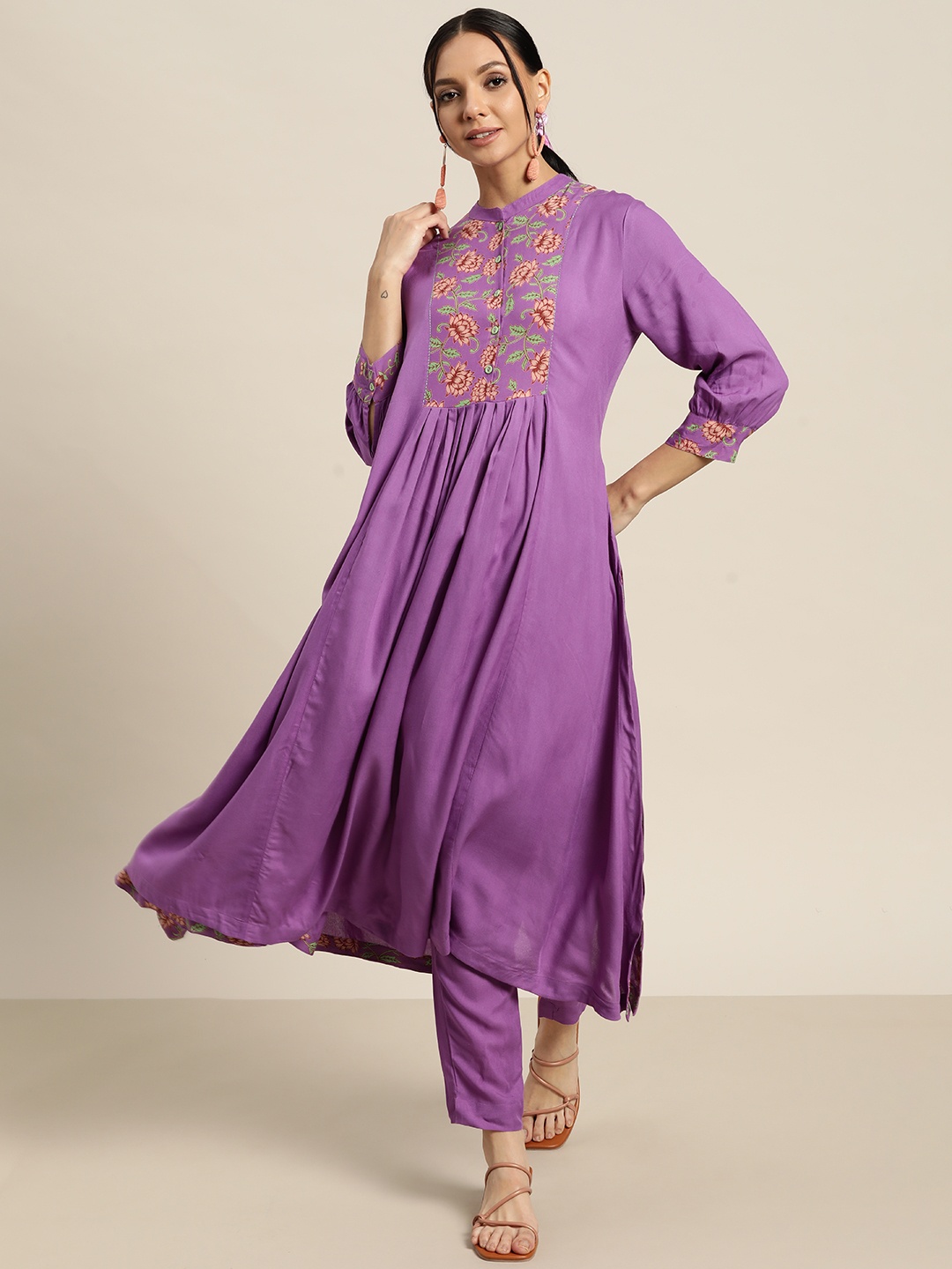 Sangria Women Purple & Peach-Coloured Ethnic Motifs Printed Pleated Kurta with Trousers
Sangria Women Purple & Peach-Coloured Ethnic Motifs Printed Pleated Kurta with Trousers