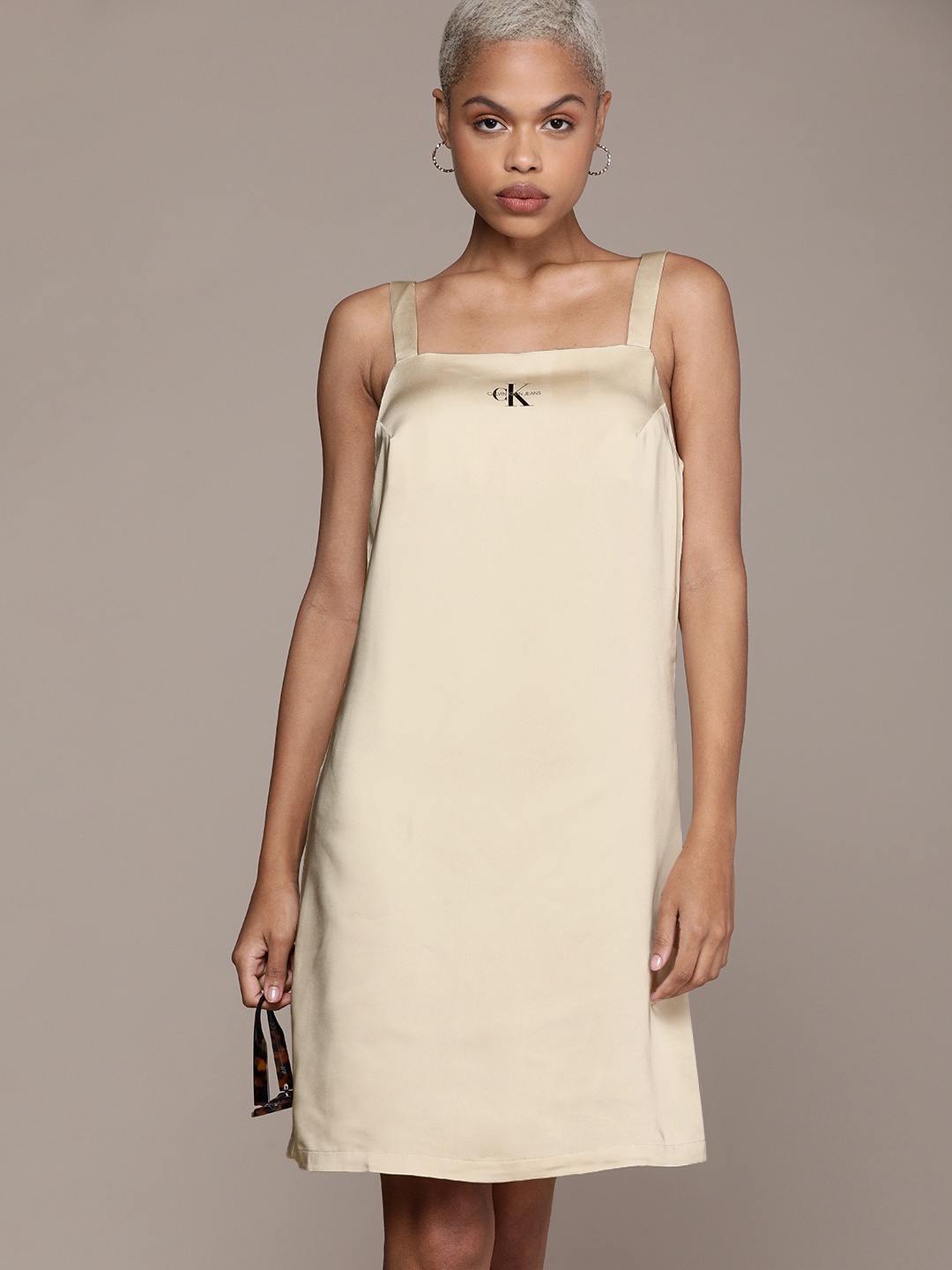 Calvin Klein Jeans Beige Shoulder Straps Satin Sheath Dress with Brand Logo Print Detail
Calvin Klein Jeans Beige Shoulder Straps Satin Sheath Dress with Brand Logo Print Detail
