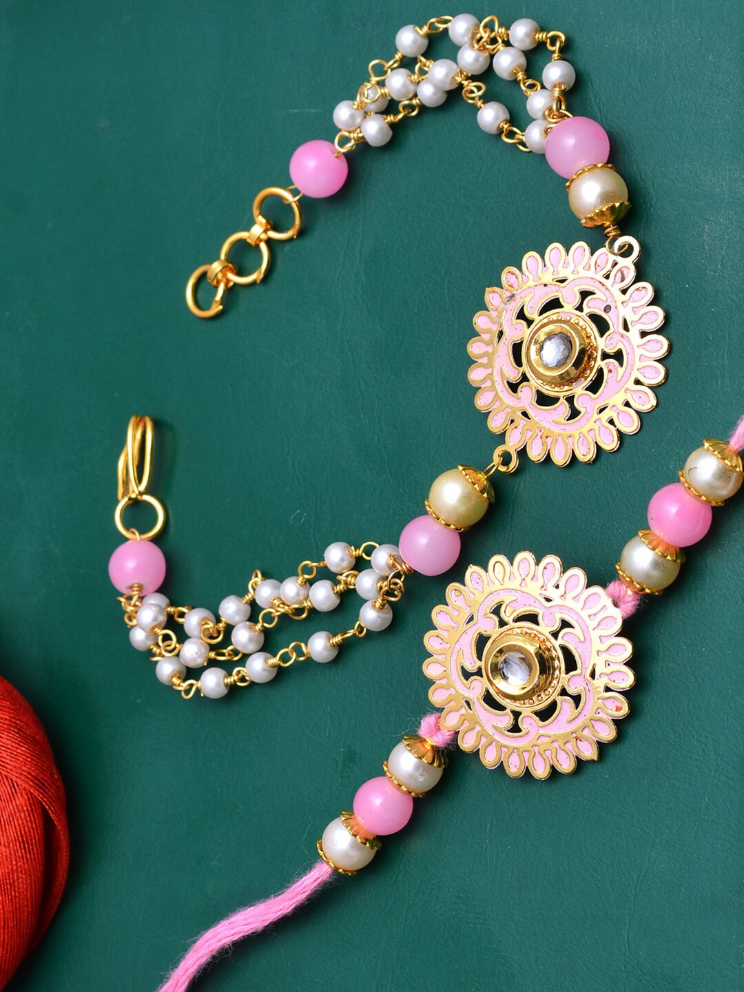 PANASH Gold-Toned & Pink Brass Floral Handcrafted Rakhi & Lumba Bracelet With Roli Chawal
PANASH Gold-Toned & Pink Brass Floral Handcrafted Rakhi & Lumba Bracelet With Roli Chawal