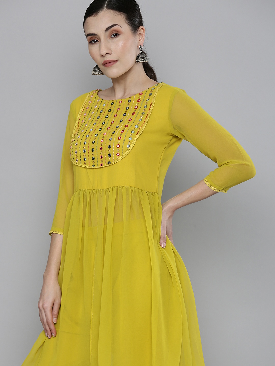 Kvsfab Women Yellow & Green Yoke Embroidered & Mirror Work Pleated Kurta with Sharara
Kvsfab Women Yellow & Green Yoke Embroidered & Mirror Work Pleated Kurta with Sharara