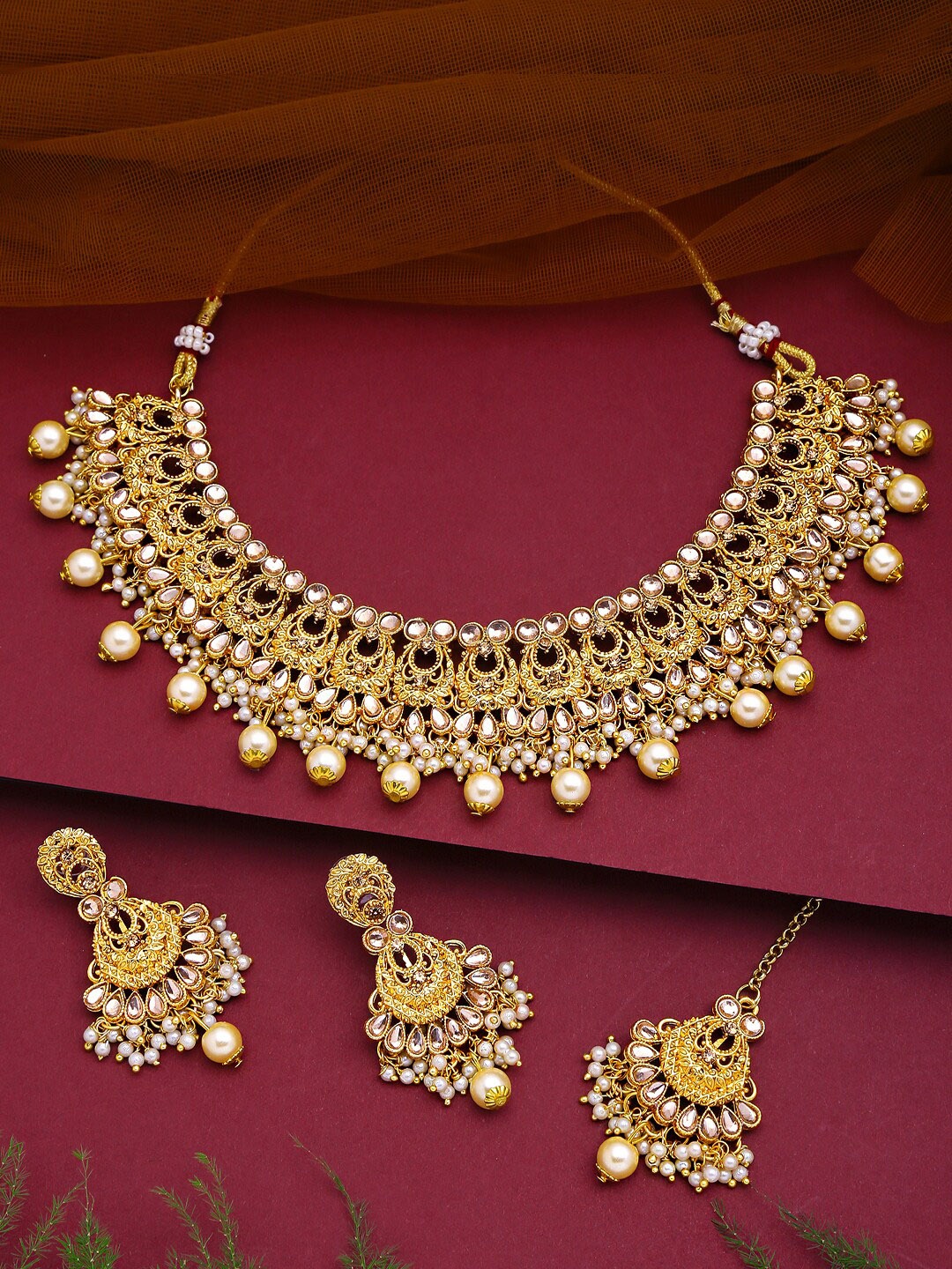 Yellow Chimes Women Gold-Toned & Plated Kundan Antique Jewellery Set With Maang Tikka
Yellow Chimes Women Gold-Toned & Plated Kundan Antique Jewellery Set With Maang Tikka