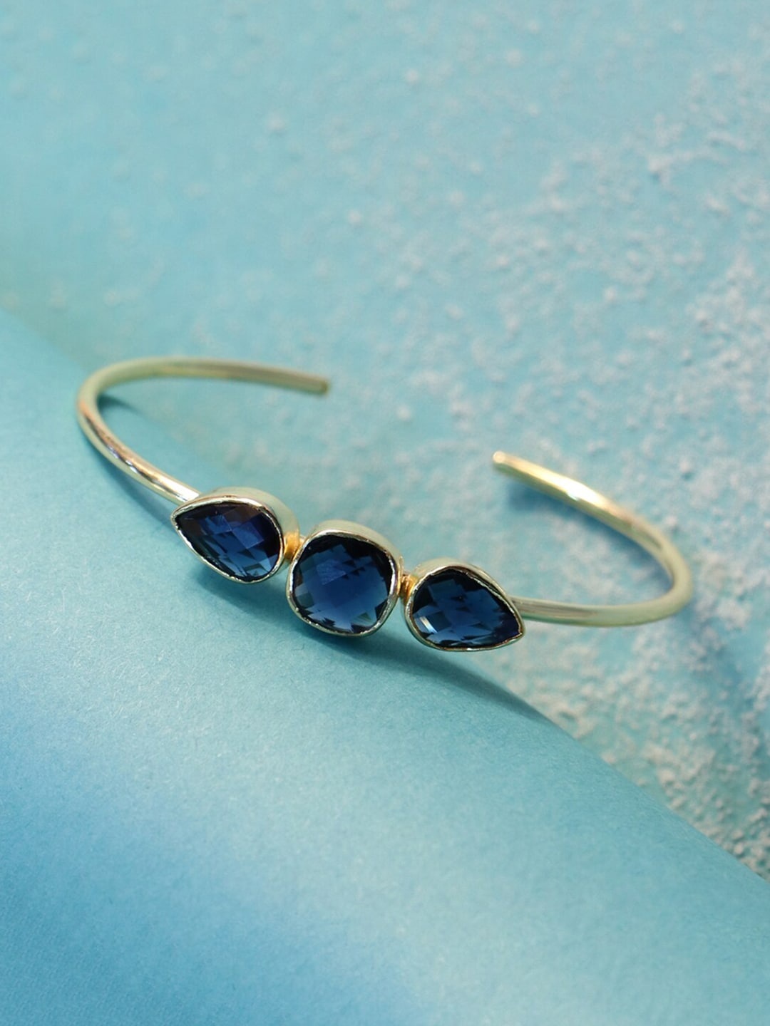 March by FableStreet Women Gold-Toned & Blue Brass Crystals Handcrafted Gold-Plated Cuff Bracelet
March by FableStreet Women Gold-Toned & Blue Brass Crystals Handcrafted Gold-Plated Cuff Bracelet