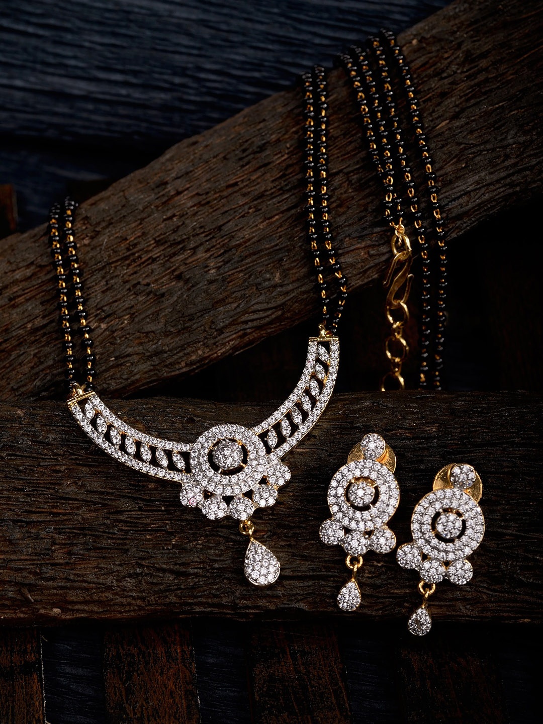 Saraf RS Jewellery Gold-Plated Black Beaded & White AD Stone-Studded Mangalsutra With Earrings
Saraf RS Jewellery Gold-Plated Black Beaded & White AD Stone-Studded Mangalsutra With Earrings