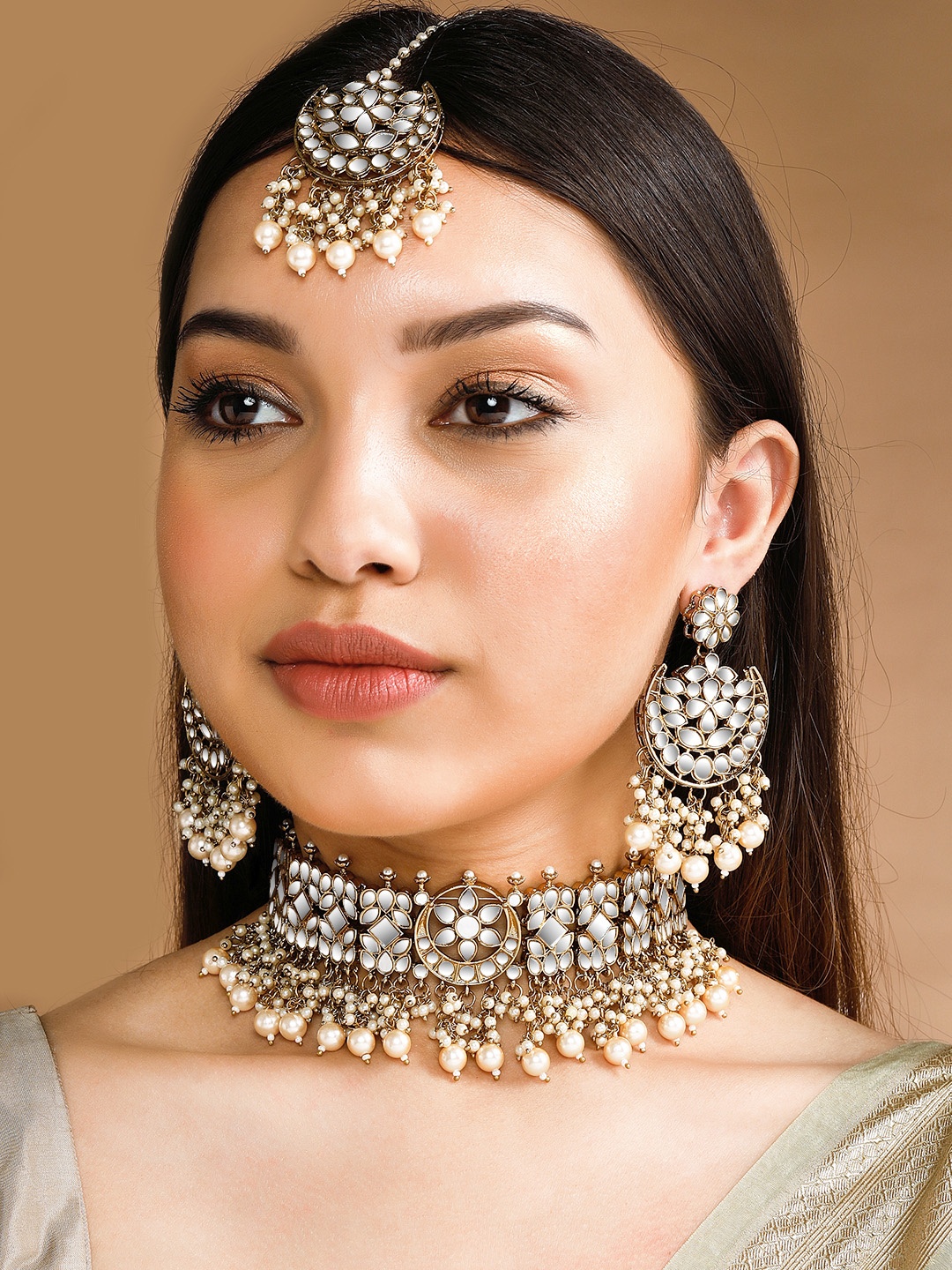 Rubans Gold-Plated & White Stone-Studded & Pearl Beaded Handcrafted Mirror Jewellery Set
Rubans Gold-Plated & White Stone-Studded & Pearl Beaded Handcrafted Mirror Jewellery Set