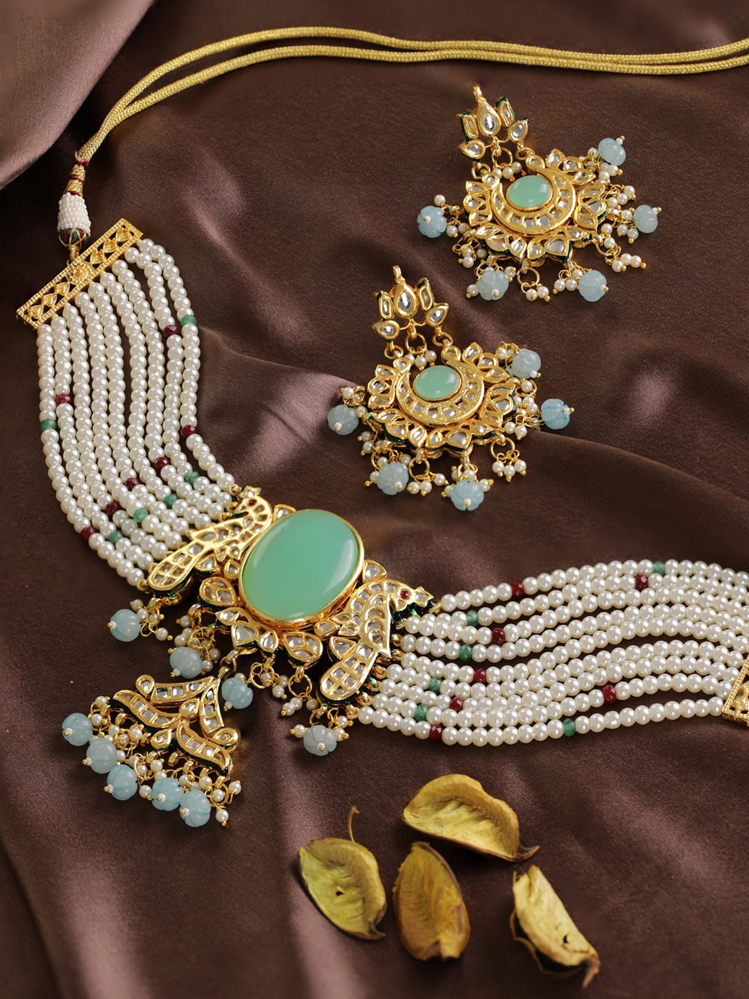 Priyaasi Women Gold-Plated Turquoise Blue & White Kundan Studded Jewellery Set
Priyaasi Women Gold-Plated Turquoise Blue & White Kundan Studded Jewellery Set