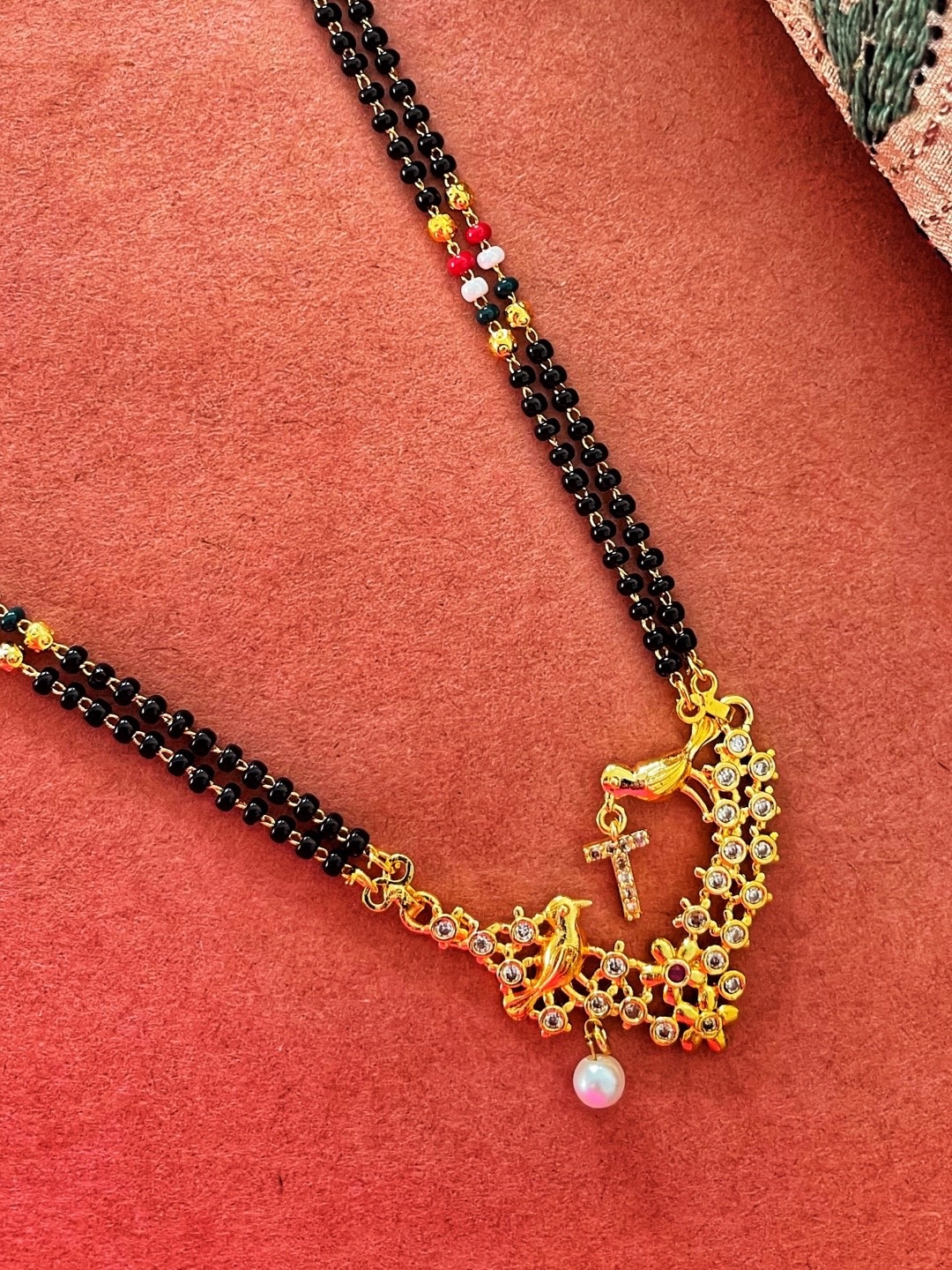 Digital Dress Room Gold-Plated Black & White Beaded & Stone-Studded T-Alphabet Mangalsutra
Digital Dress Room Gold-Plated Black & White Beaded & Stone-Studded T-Alphabet Mangalsutra