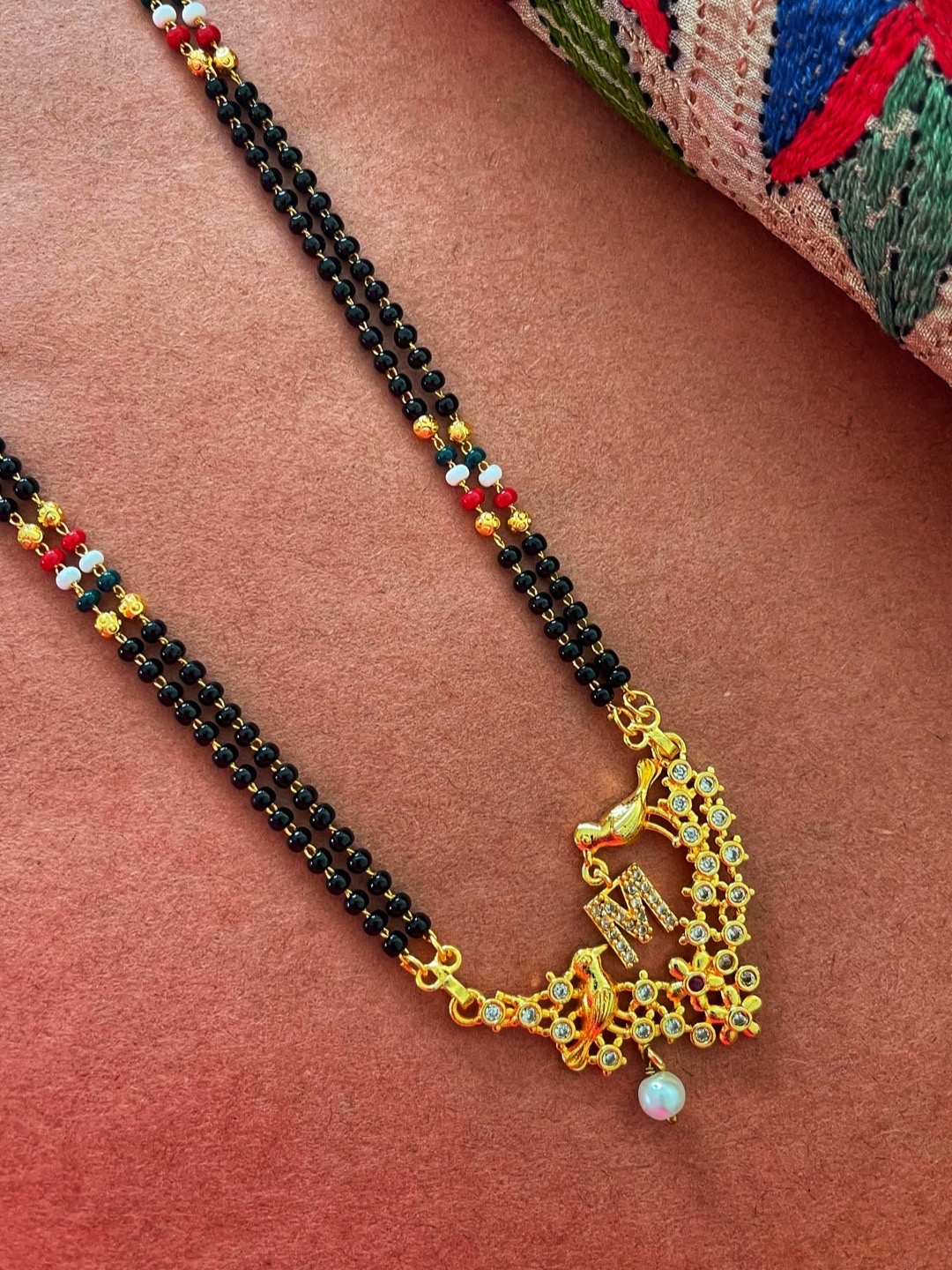 Digital Dress Room Gold-Plated Black & White Beaded & Stone-Studded M-Alphabet Mangalsutra
Digital Dress Room Gold-Plated Black & White Beaded & Stone-Studded M-Alphabet Mangalsutra