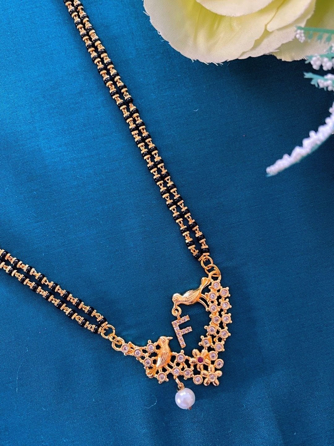 Digital Dress Room Gold-Plated Black & White Beaded & Stone-Studded F-Alphabet Mangalsutra
Digital Dress Room Gold-Plated Black & White Beaded & Stone-Studded F-Alphabet Mangalsutra
