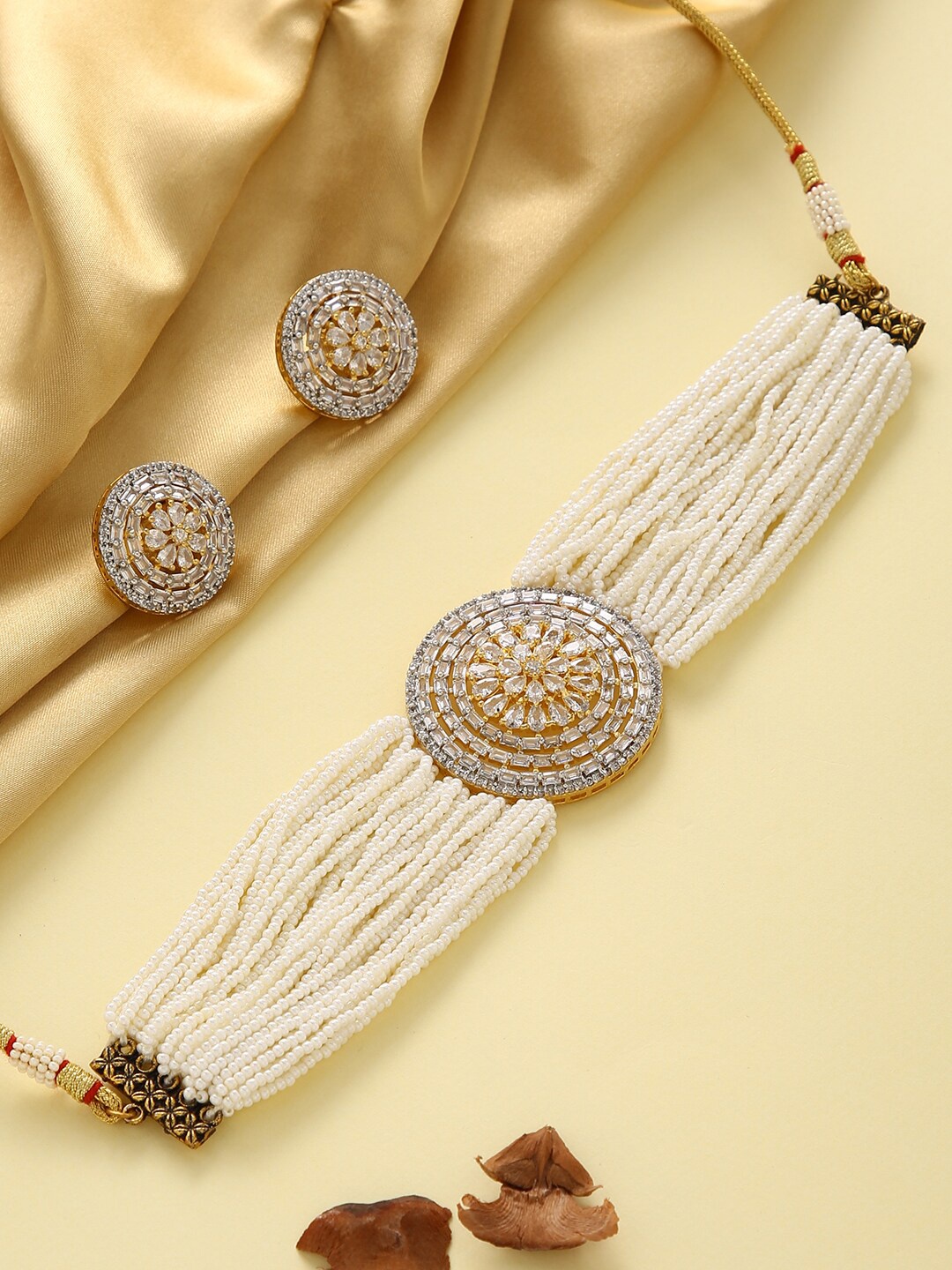 justpeachy Women Gold-Toned American Diamond Stone Studded & White Beaded Jewellery Set
justpeachy Women Gold-Toned American Diamond Stone Studded & White Beaded Jewellery Set