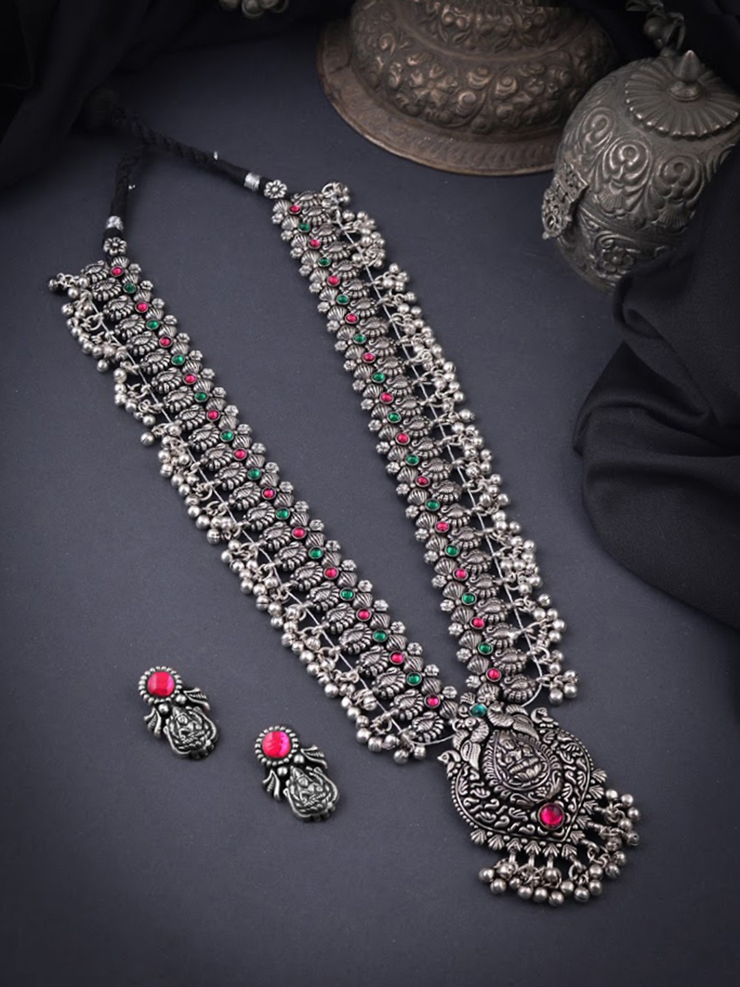 Yellow Chimes Oxidised Silver-Plated Pink & Green Stones-Studded Temple Jewellery Set
Yellow Chimes Oxidised Silver-Plated Pink & Green Stones-Studded Temple Jewellery Set