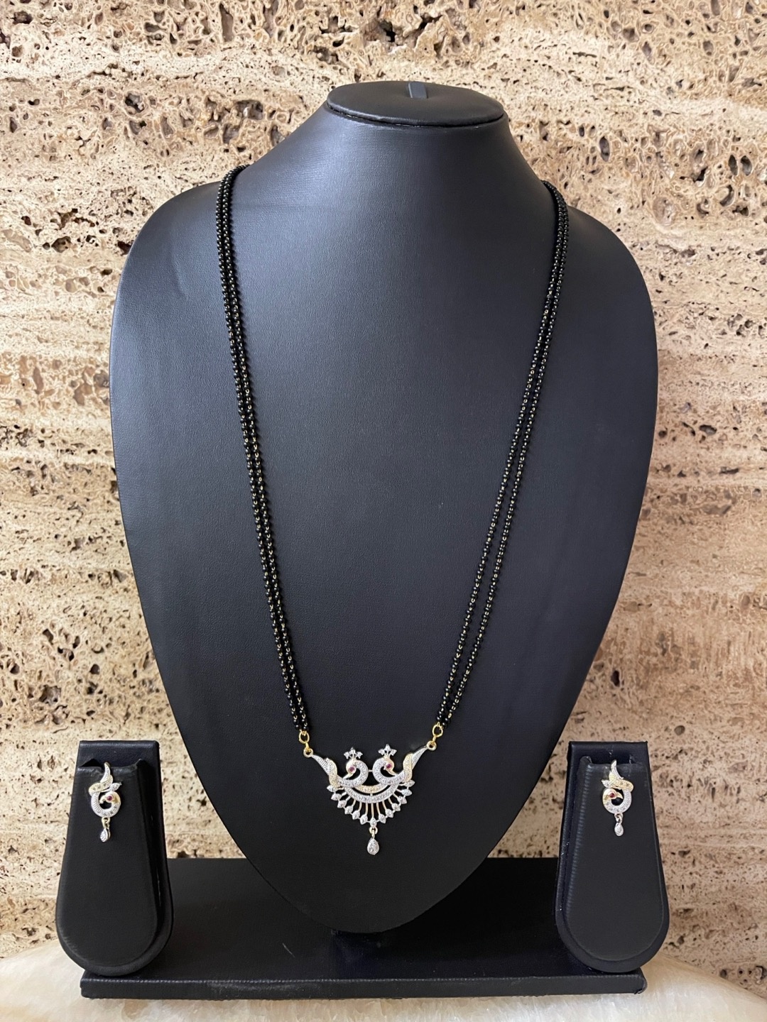 Digital Dress Room Gold-Plated White & Black Stone-Studded Beaded Mangalsutra With Earrings
Digital Dress Room Gold-Plated White & Black Stone-Studded Beaded Mangalsutra With Earrings