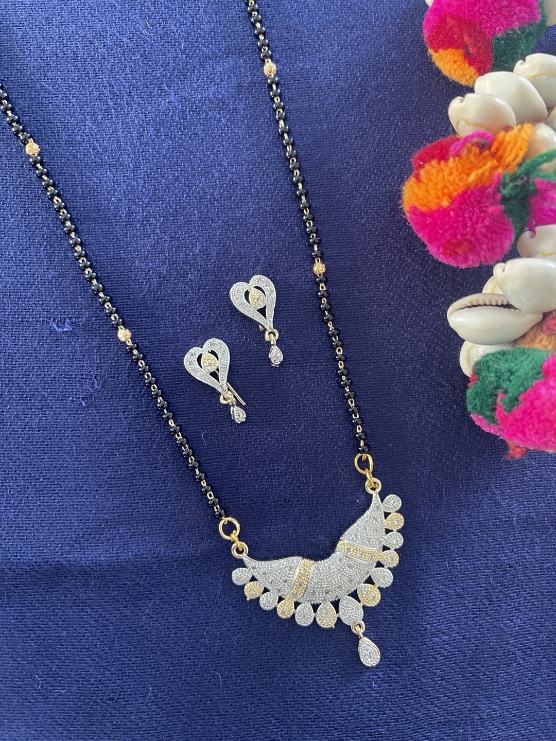 Digital Dress Room Gold-Plated White American Diamond Studded & Black Beaded Mangalsutra
Digital Dress Room Gold-Plated White American Diamond Studded & Black Beaded Mangalsutra