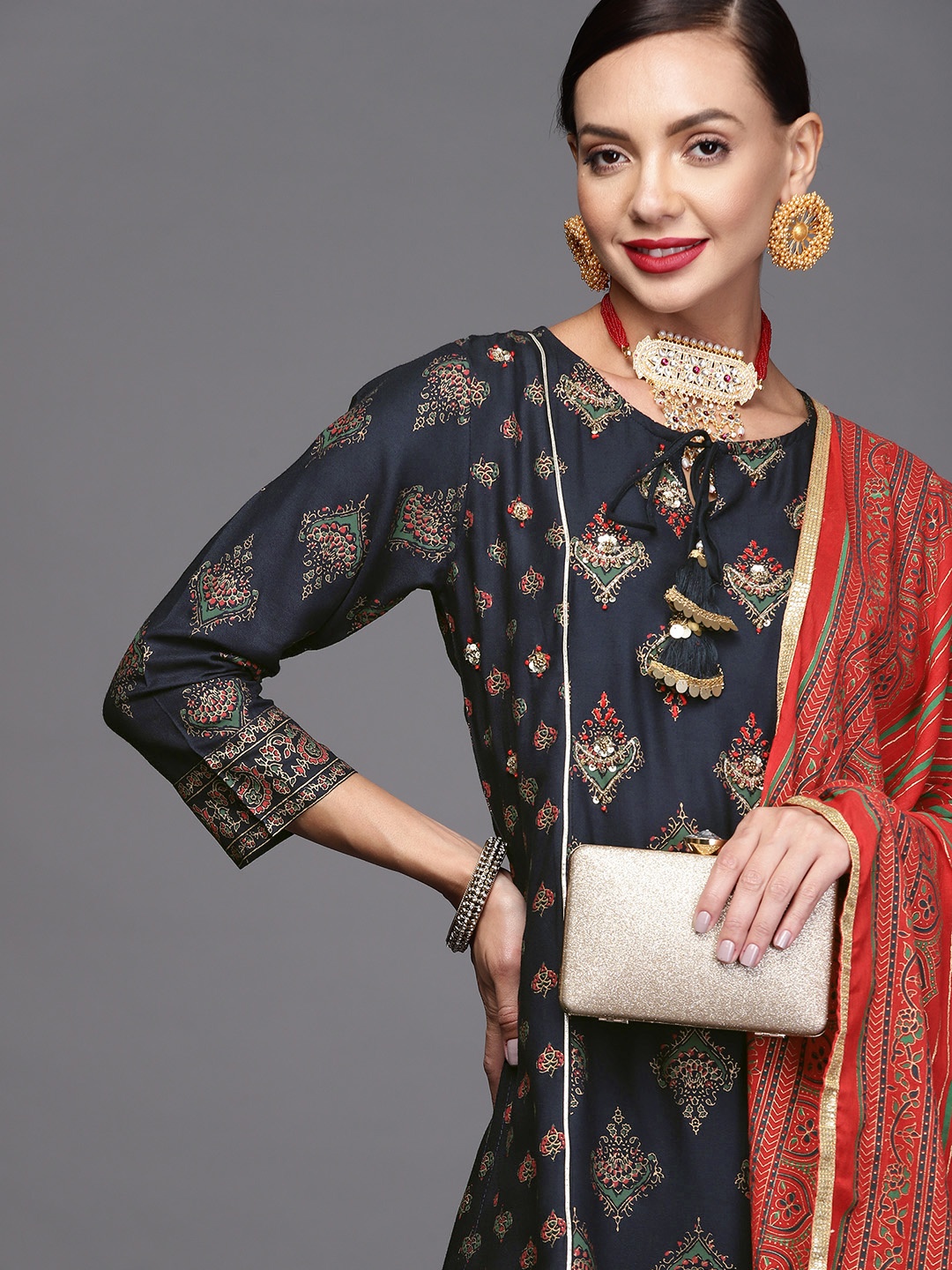 Indo Era Women Navy Blue & Golden Ethnic Motifs Printed Kurta with Trousers & Dupatta
Indo Era Women Navy Blue & Golden Ethnic Motifs Printed Kurta with Trousers & Dupatta