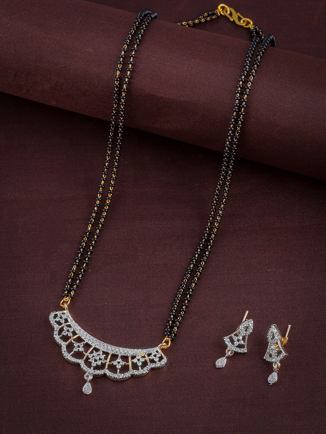 Brandsoon Gold-Plated White AD-Studded & Black Beaded Mangalsutra With Earring
Brandsoon Gold-Plated White AD-Studded & Black Beaded Mangalsutra With Earring