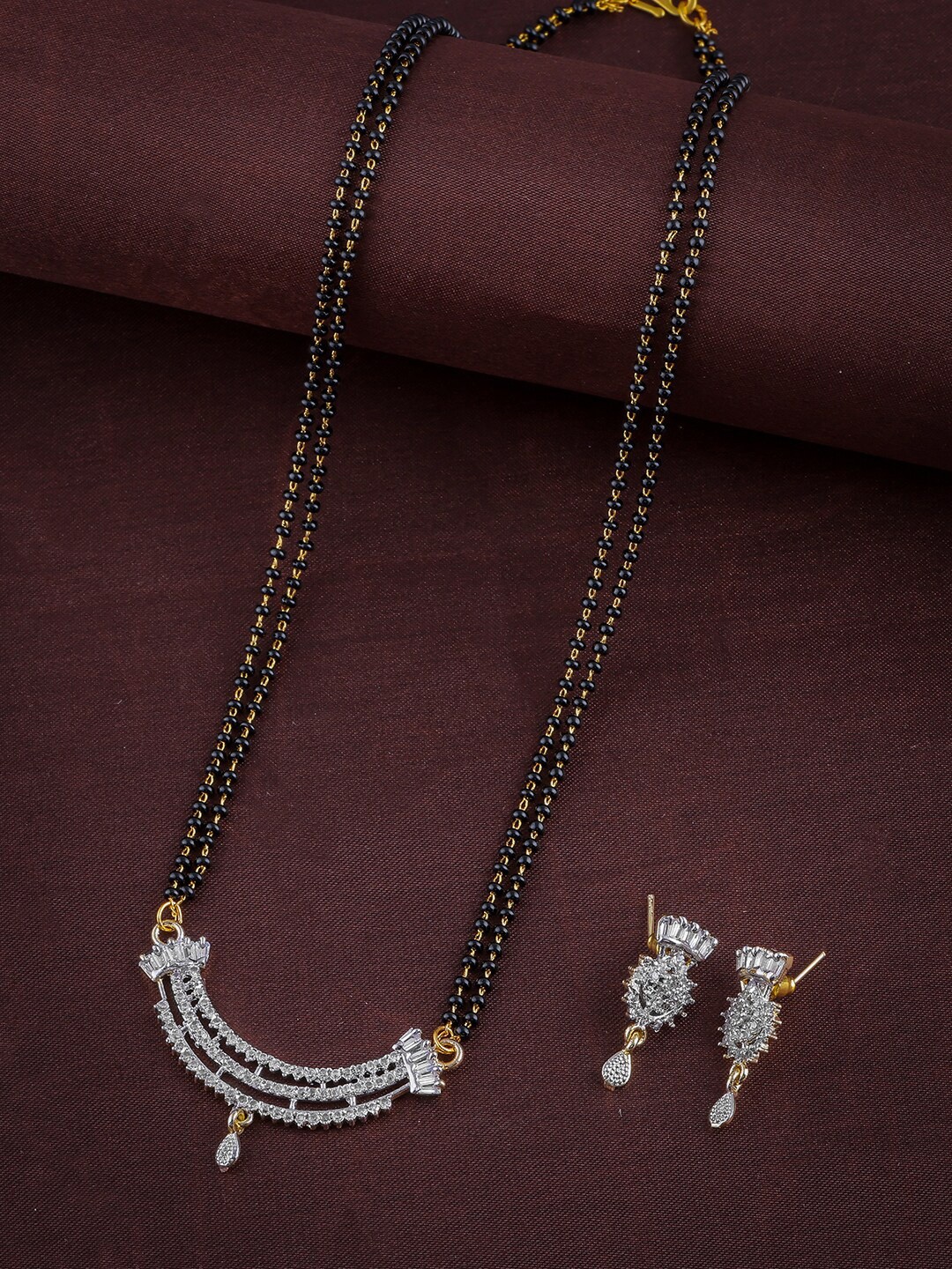 Brandsoon Women Gold-Plated Black & White AD-Studded Beaded Mangalsutra With Earrings
Brandsoon Women Gold-Plated Black & White AD-Studded Beaded Mangalsutra With Earrings