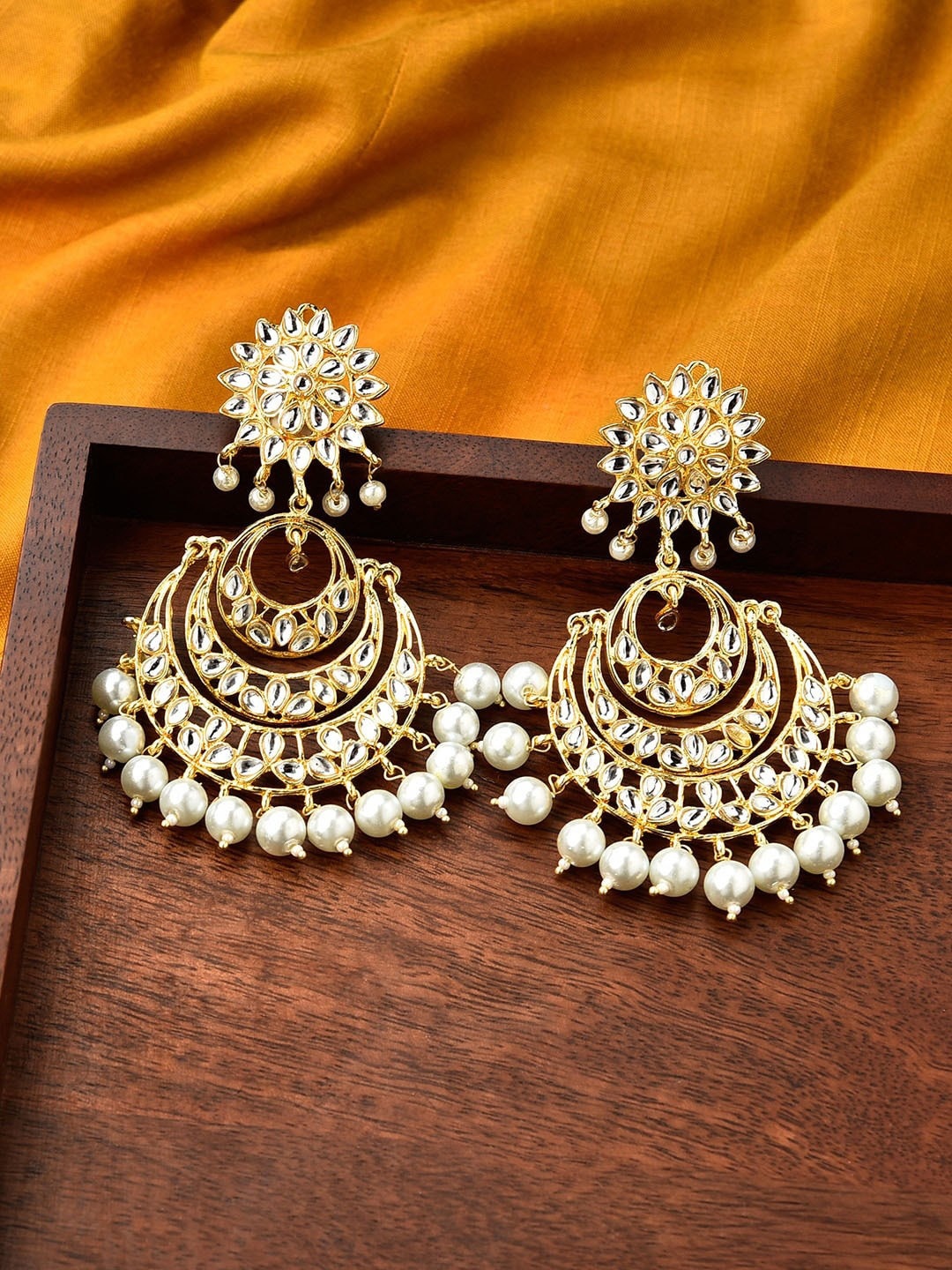 Fida Women Gold-Plated White Kundan Studded Bangles & Pearl Drop Chandbali Earrings Set
Fida Women Gold-Plated White Kundan Studded Bangles & Pearl Drop Chandbali Earrings Set