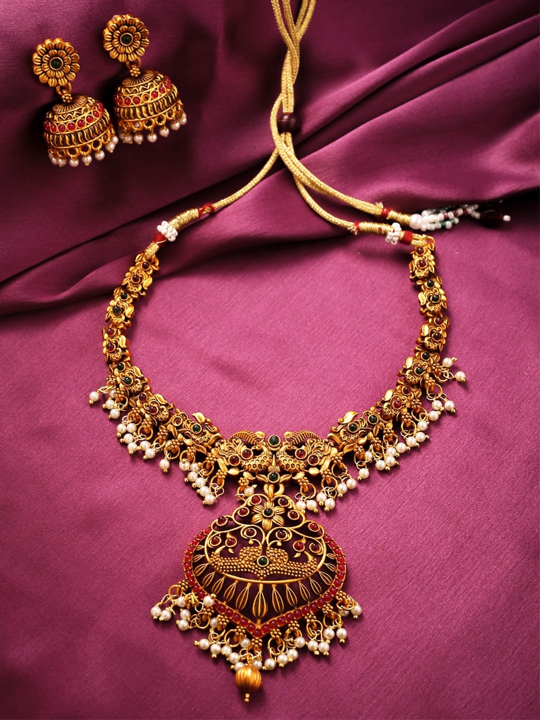 Yellow Chimes Women Gold-Plated White Stone-Studded & Pearl Beaded Temple Jewellery Set
Yellow Chimes Women Gold-Plated White Stone-Studded & Pearl Beaded Temple Jewellery Set