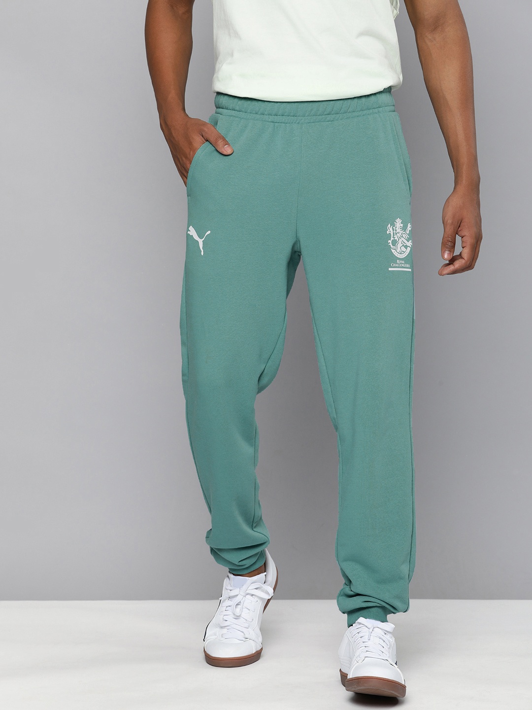 Puma x Royal Challengers Bangalore Men Sea Green Graphic Printed Regular Fit Joggers
Puma x Royal Challengers Bangalore Men Sea Green Graphic Printed Regular Fit Joggers