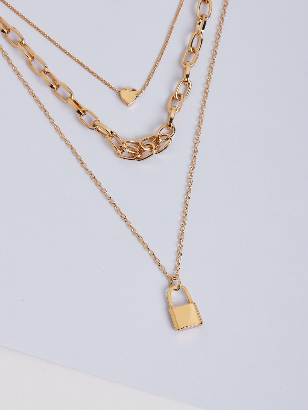 Lilly & sparkle Gold-Plated Three Layered Necklace With Link Chain Lock And Heart Charm
Lilly & sparkle Gold-Plated Three Layered Necklace With Link Chain Lock And Heart Charm