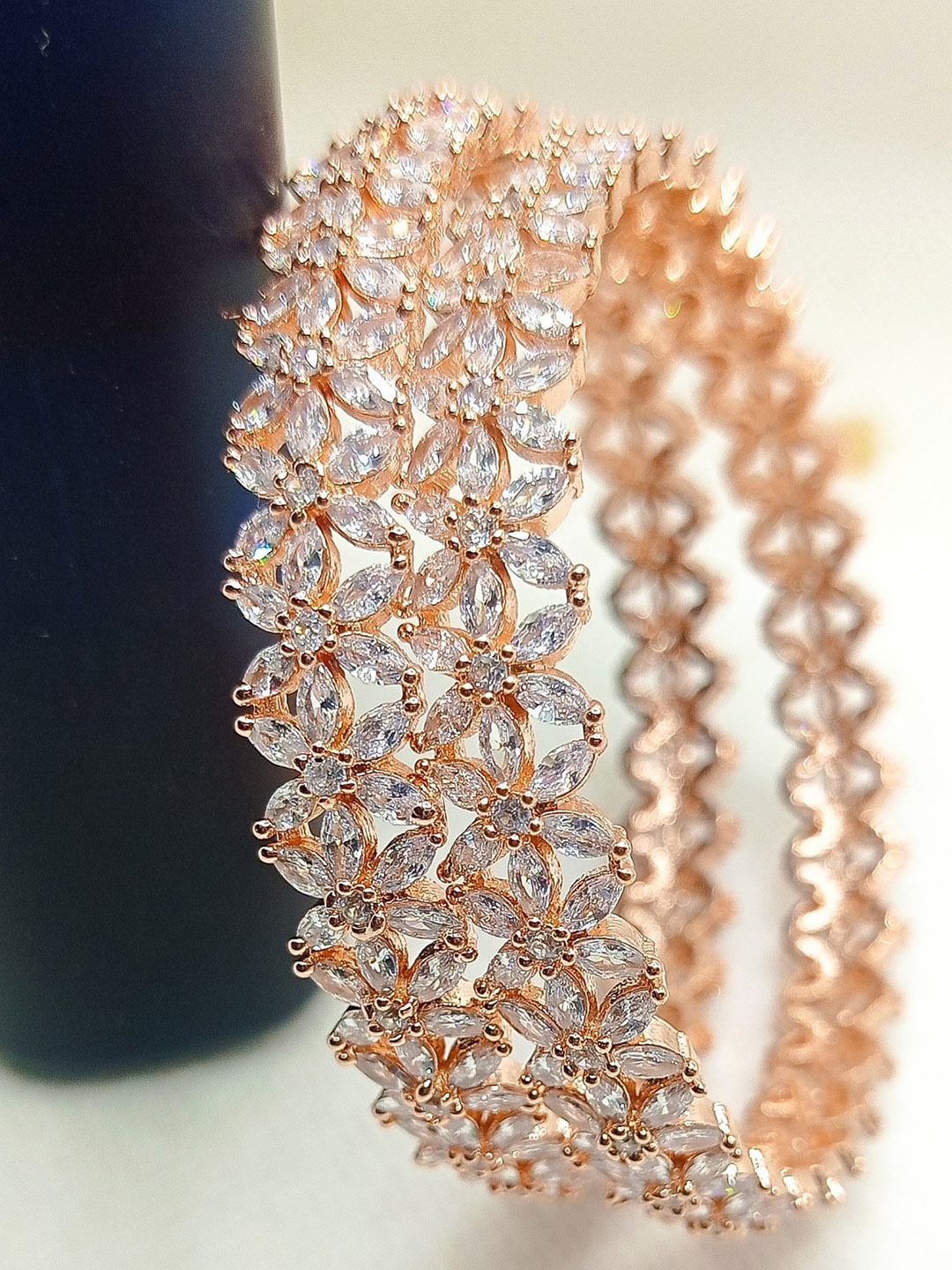 Nathany Jewels Set Of 2 Rose Gold-Plated White AD-Studded Flower Design Bangles
Nathany Jewels Set Of 2 Rose Gold-Plated White AD-Studded Flower Design Bangles