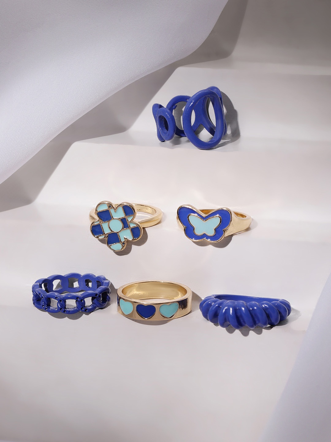 TOKYO TALKIES X rubans FASHION ACCESSORIES Set Of 6 Gold-Plated & Blue Finger Rings
TOKYO TALKIES X rubans FASHION ACCESSORIES Set Of 6 Gold-Plated & Blue Finger Rings