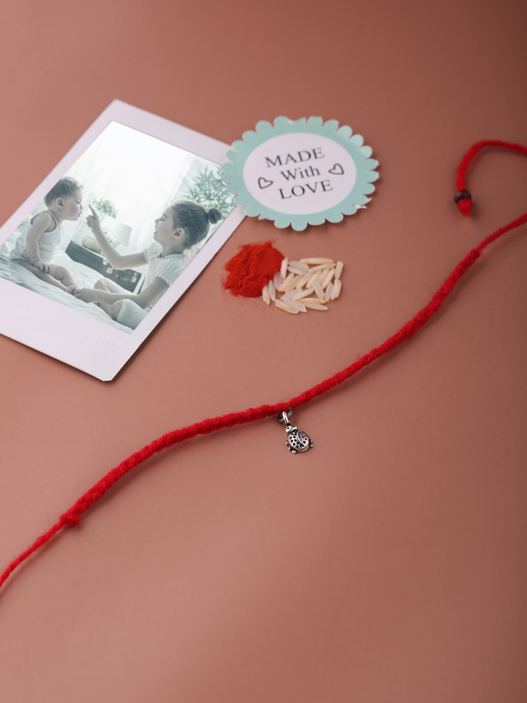 ADORN by Nikita Ladiwala Kids 92.5 Sterling Silver Bug Charm Rakhi With Roli Chawal
ADORN by Nikita Ladiwala Kids 92.5 Sterling Silver Bug Charm Rakhi With Roli Chawal