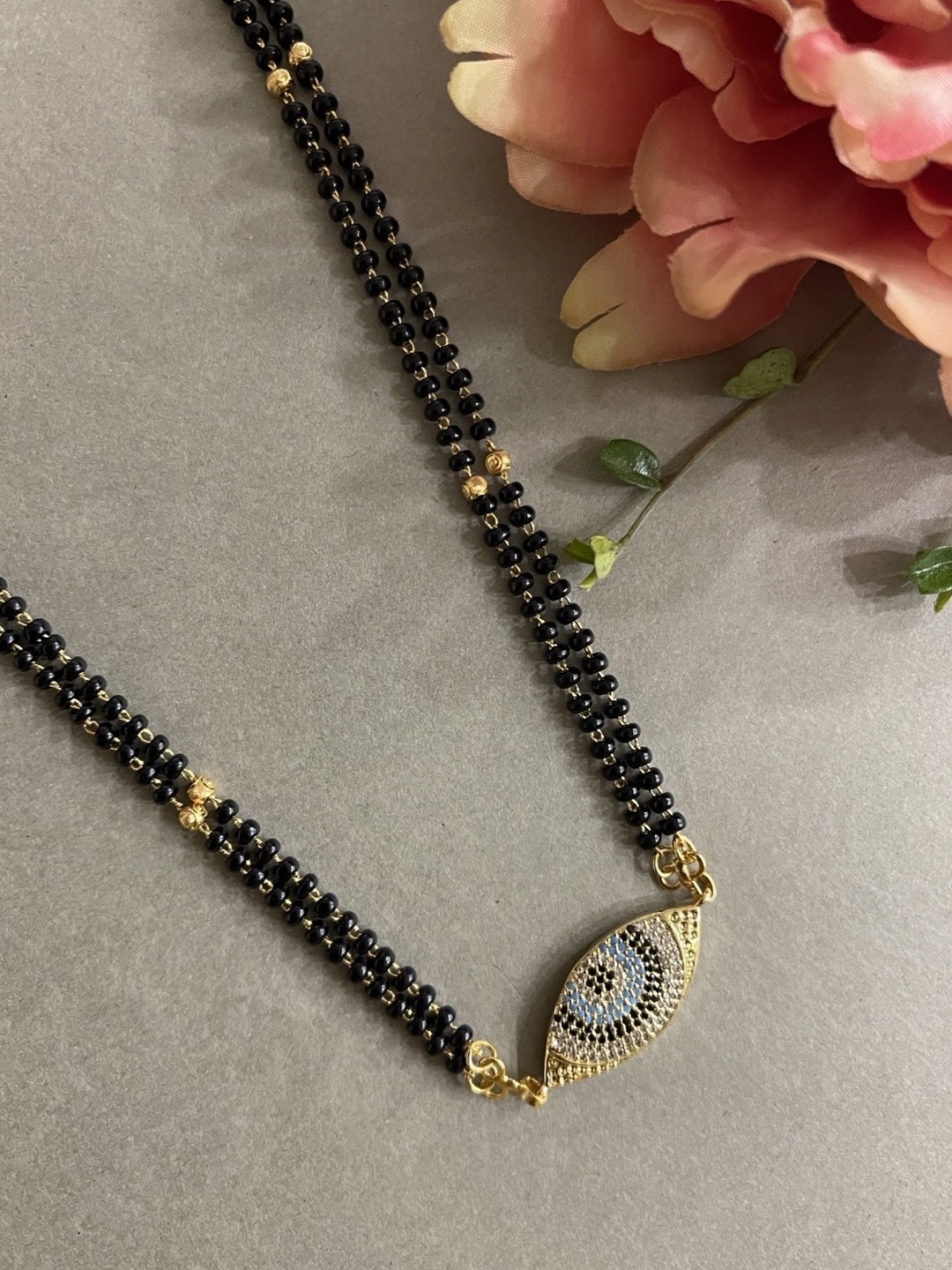Digital Dress Room Gold-Plated Multi-Coloured Stone-Studded & Black Beaded Mangalsutra
Digital Dress Room Gold-Plated Multi-Coloured Stone-Studded & Black Beaded Mangalsutra