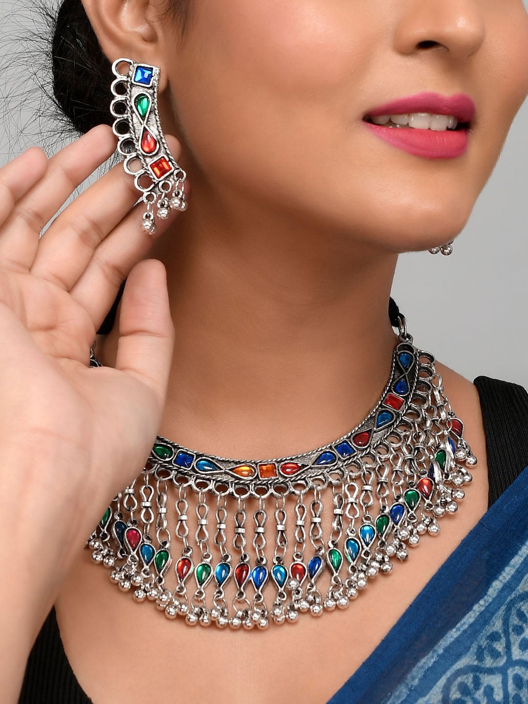 AQUASTREET JEWELS Oxidised Silver-Plated Red & Blue Stone Studded Afghani Tassel Jewellery Set
AQUASTREET JEWELS Oxidised Silver-Plated Red & Blue Stone Studded Afghani Tassel Jewellery Set