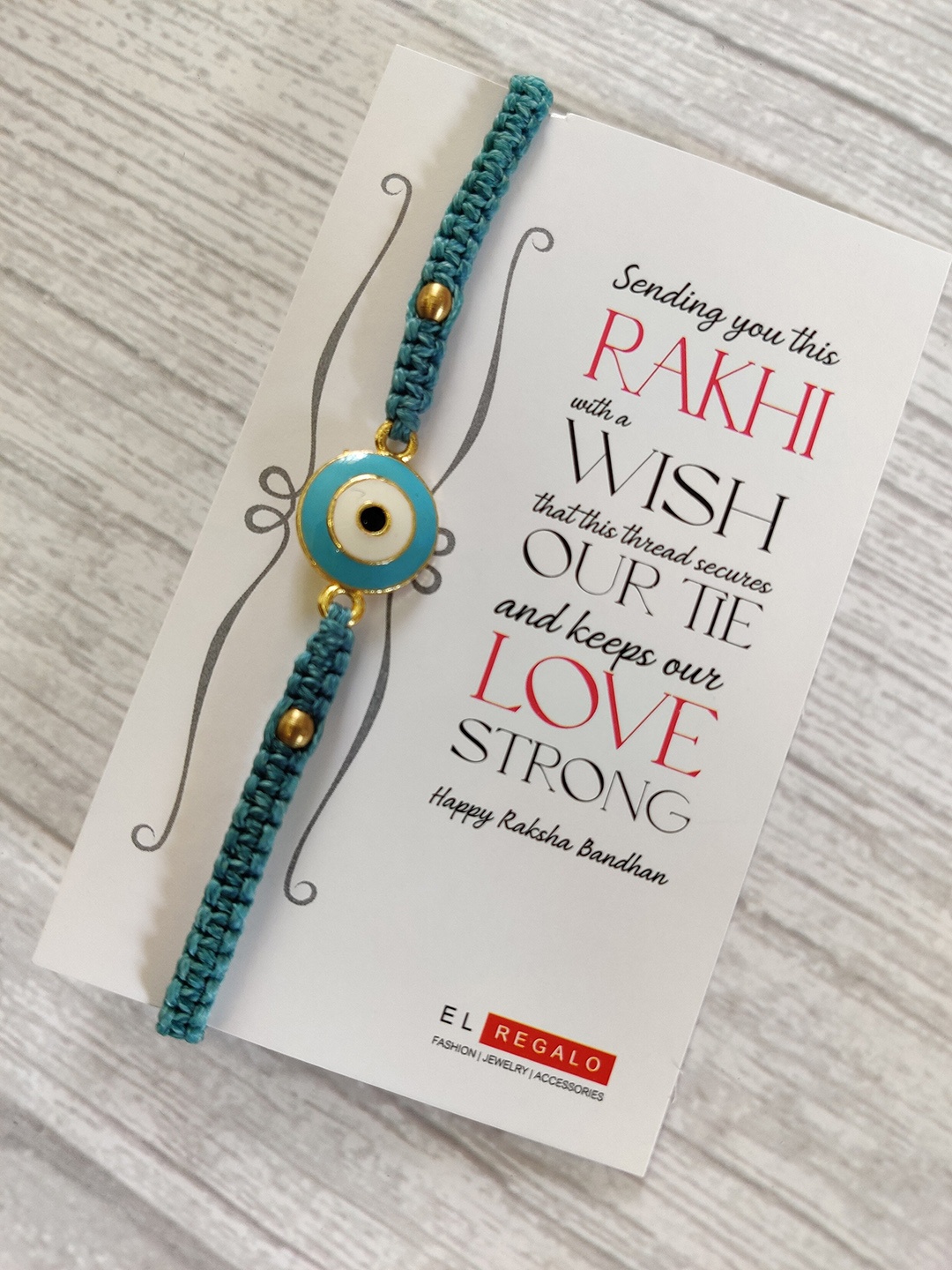 EL REGALO Evil Eye Rakhi Combo for Bhaiya With Roli Chawal Shagun and Greeting Card, Blue
EL REGALO Evil Eye Rakhi Combo for Bhaiya With Roli Chawal Shagun and Greeting Card, Blue