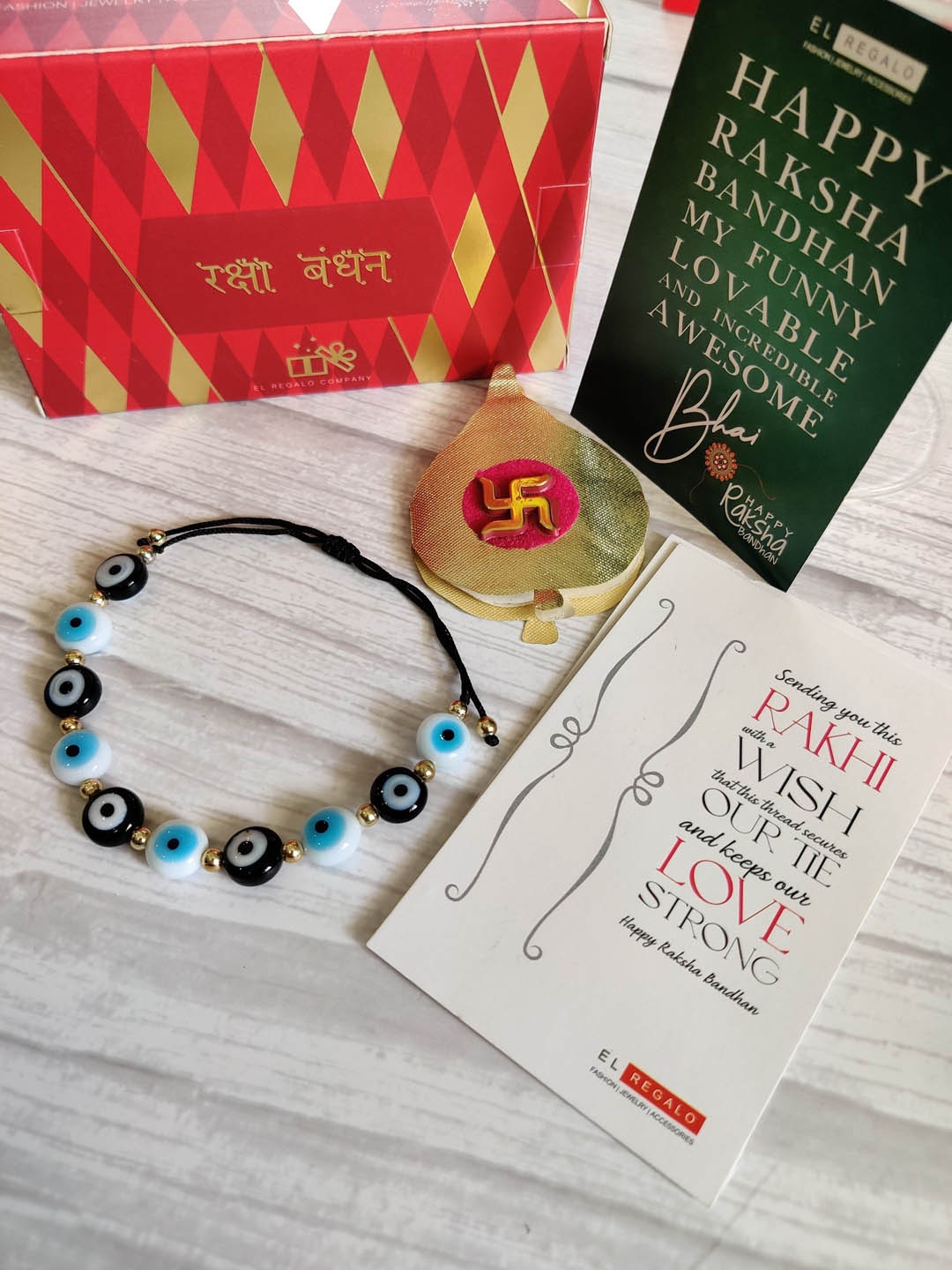 EL REGALO Evil Eye Rakhi Combo for Bhaiya With Roli Chawal Shagun and Greeting Card, Blue
EL REGALO Evil Eye Rakhi Combo for Bhaiya With Roli Chawal Shagun and Greeting Card, Blue
