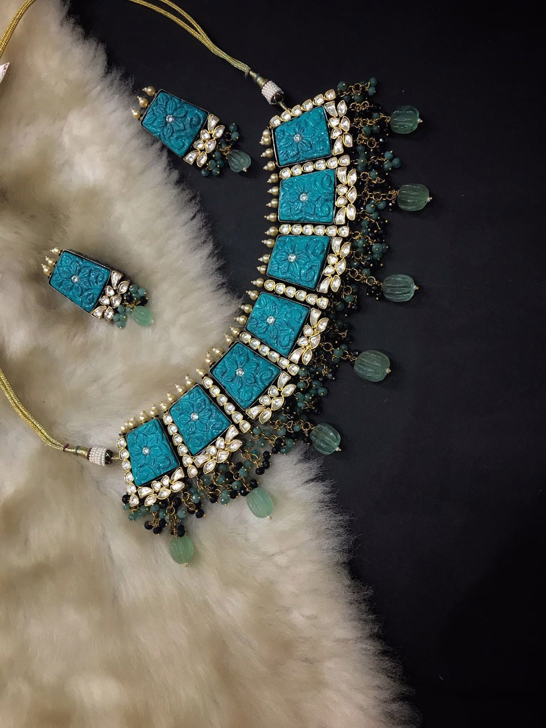 SURYAM DESIGNER JEWELLERY Women Gold-Plated Blue Carving Stone-Studded & Pista Green Beaded Jewellery Set
SURYAM DESIGNER JEWELLERY Women Gold-Plated Blue Carving Stone-Studded & Pista Green Beaded Jewellery Set