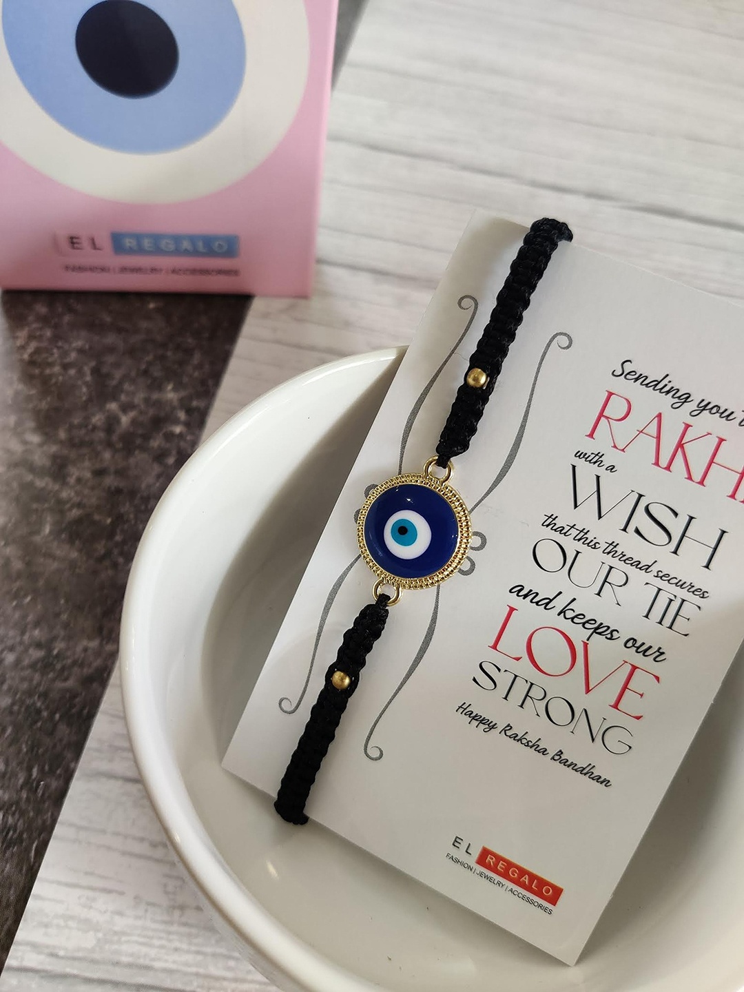 EL REGALO Evil Eye Rakhi Combo for Bhaiya With Roli Chawal Shagun and Greeting Card, Blue
EL REGALO Evil Eye Rakhi Combo for Bhaiya With Roli Chawal Shagun and Greeting Card, Blue