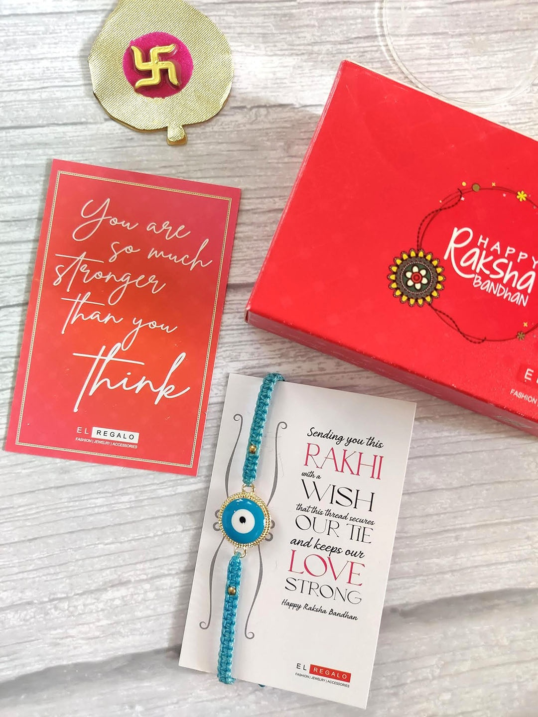 EL REGALO Evil Eye Rakhi Combo for Bhaiya With Roli Chawal Shagun and Greeting Card, Blue
EL REGALO Evil Eye Rakhi Combo for Bhaiya With Roli Chawal Shagun and Greeting Card, Blue