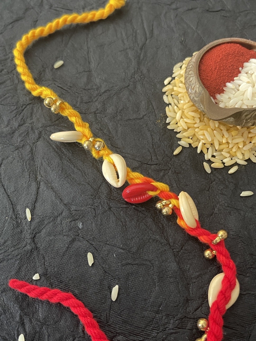 Digital Dress Room Men Red & Yellow Sea-Shell & Ghungroo Beaded Rakhi With Roli Chawal
Digital Dress Room Men Red & Yellow Sea-Shell & Ghungroo Beaded Rakhi With Roli Chawal