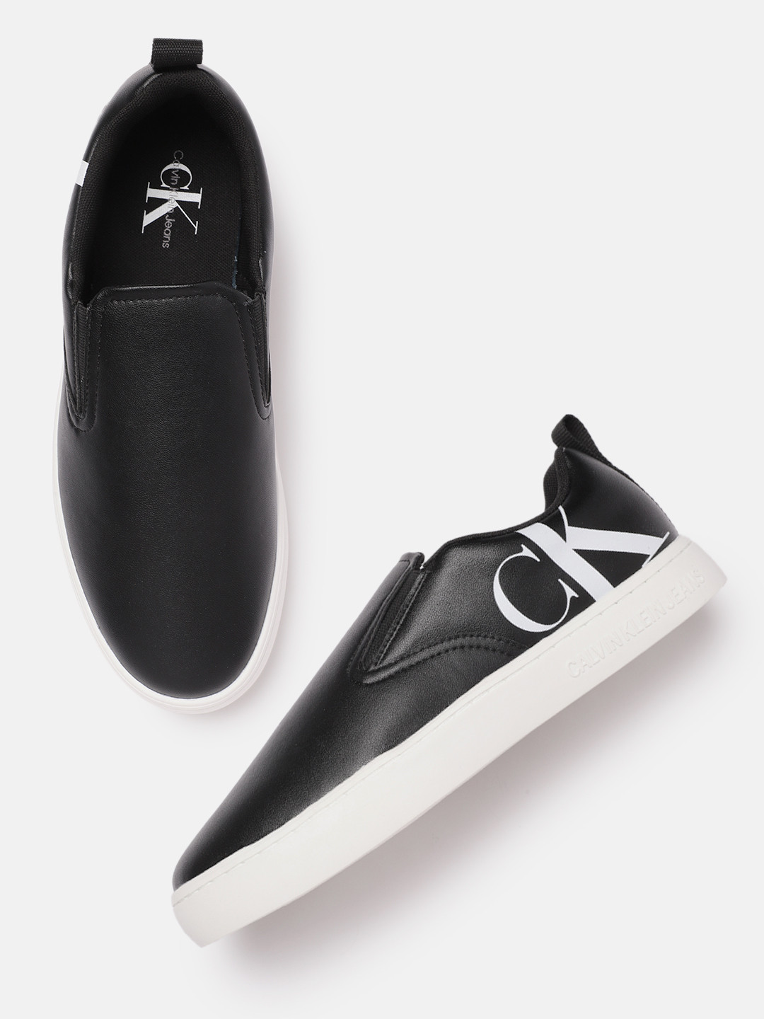 Calvin Klein Men Black Solid Leather Regular Slip-On Sneakers With Brand Logo Print Detail
Calvin Klein Men Black Solid Leather Regular Slip-On Sneakers With Brand Logo Print Detail