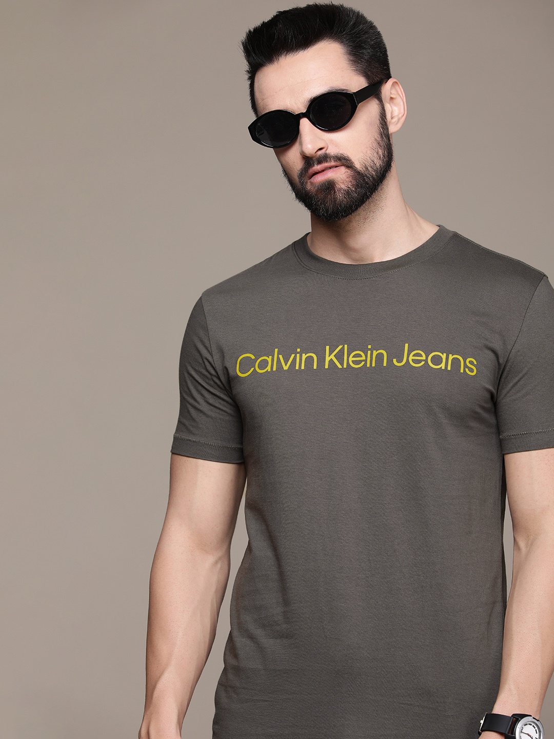 Calvin Klein Jeans Men Charcoal Grey & Yellow Typography Printed Pure Cotton T-shirt
Calvin Klein Jeans Men Charcoal Grey & Yellow Typography Printed Pure Cotton T-shirt