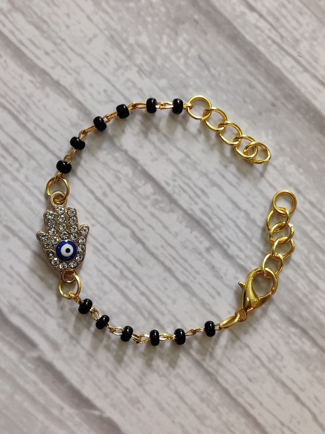 EL REGALO Kids Gold-Toned Nazaria Rakhi Combo with Greeting Card & Roli Chawal Shagun
EL REGALO Kids Gold-Toned Nazaria Rakhi Combo with Greeting Card & Roli Chawal Shagun