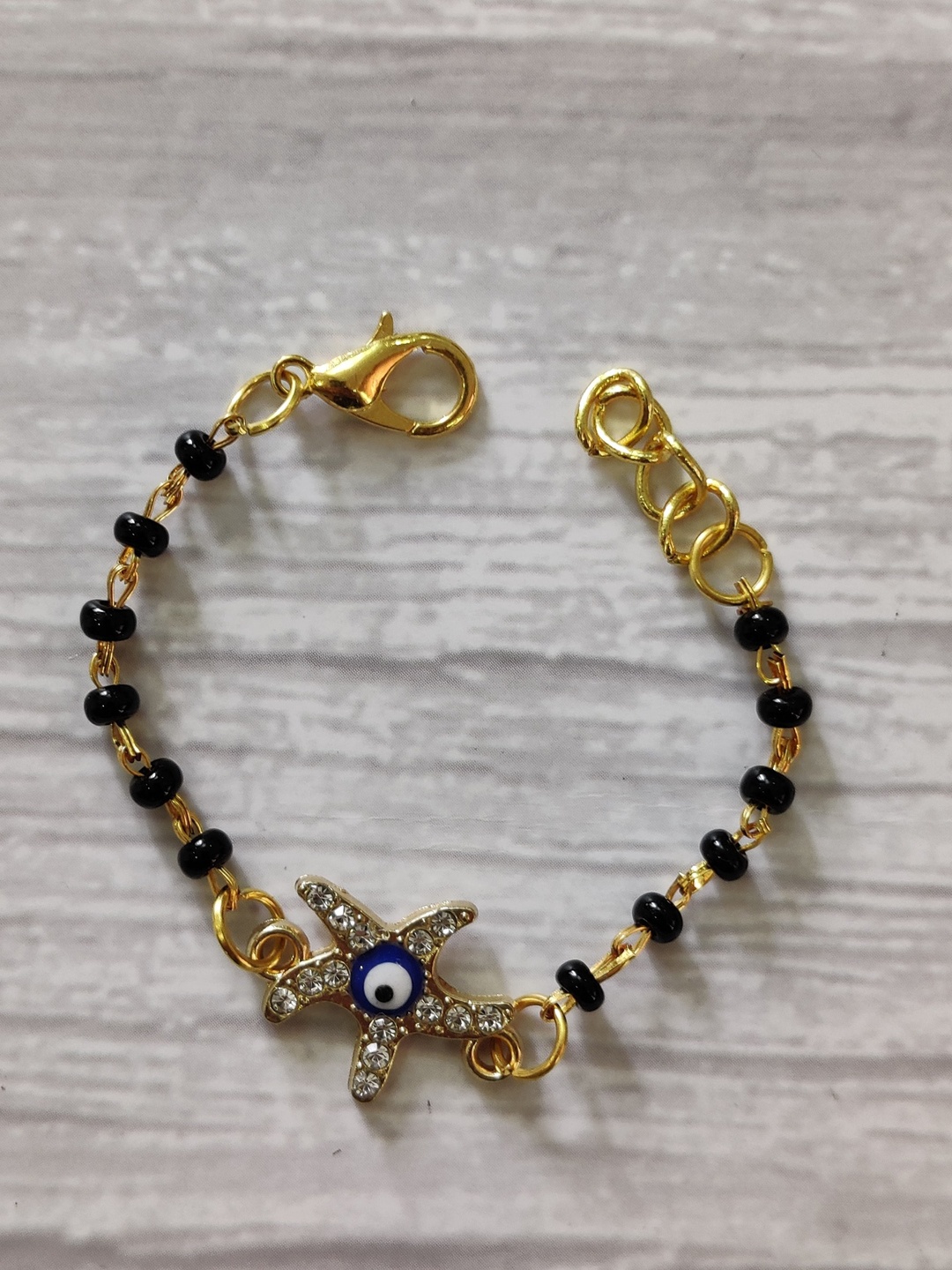 EL REGALO Kids Gold-Toned Nazaria Rakhi Combo with Greeting Card & Roli Chawal Shagun
EL REGALO Kids Gold-Toned Nazaria Rakhi Combo with Greeting Card & Roli Chawal Shagun