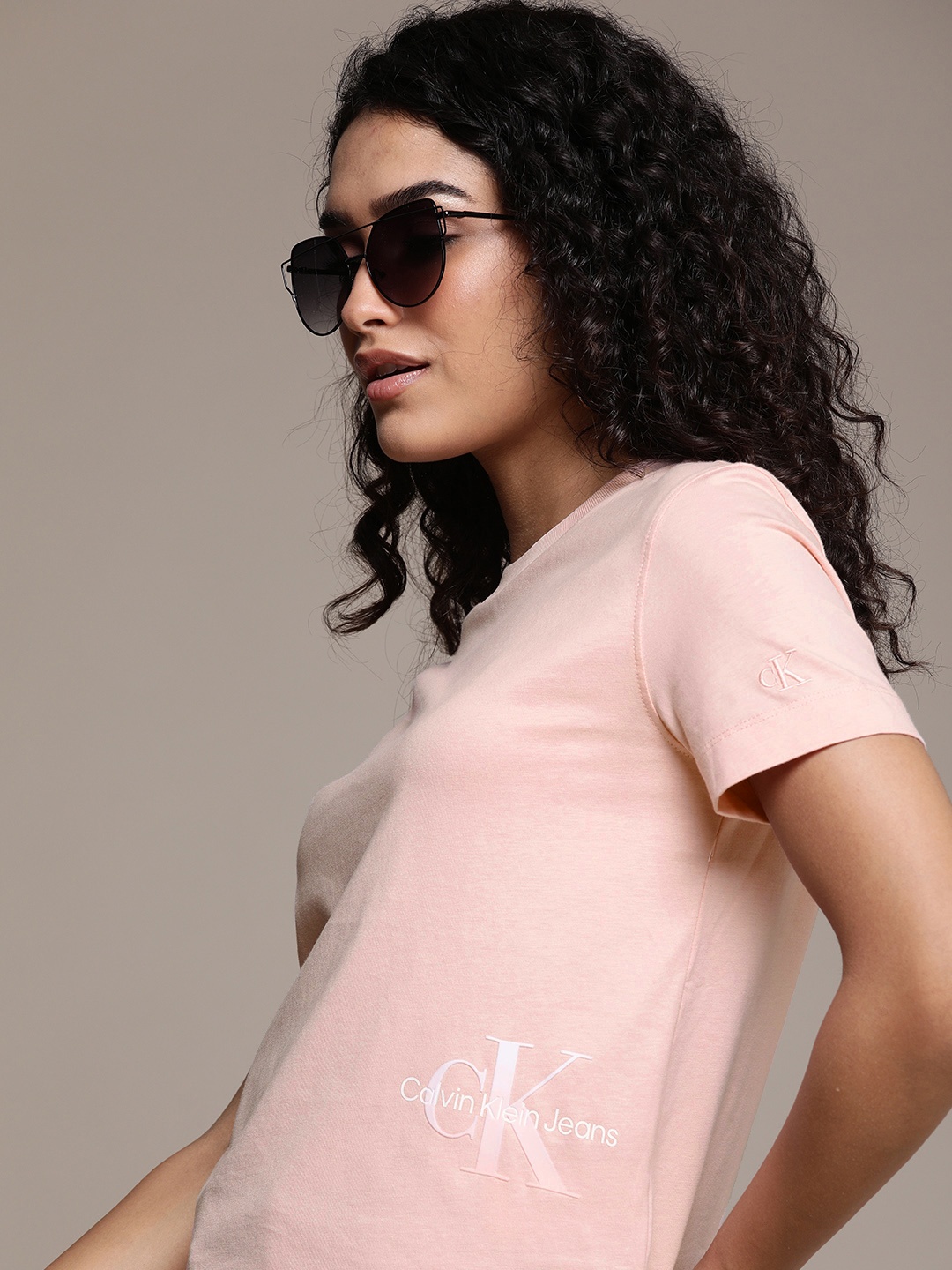 Calvin Klein Jeans Women Peach-Coloured Brand Logo Printed Pure Cotton Applique T-shirt
Calvin Klein Jeans Women Peach-Coloured Brand Logo Printed Pure Cotton Applique T-shirt