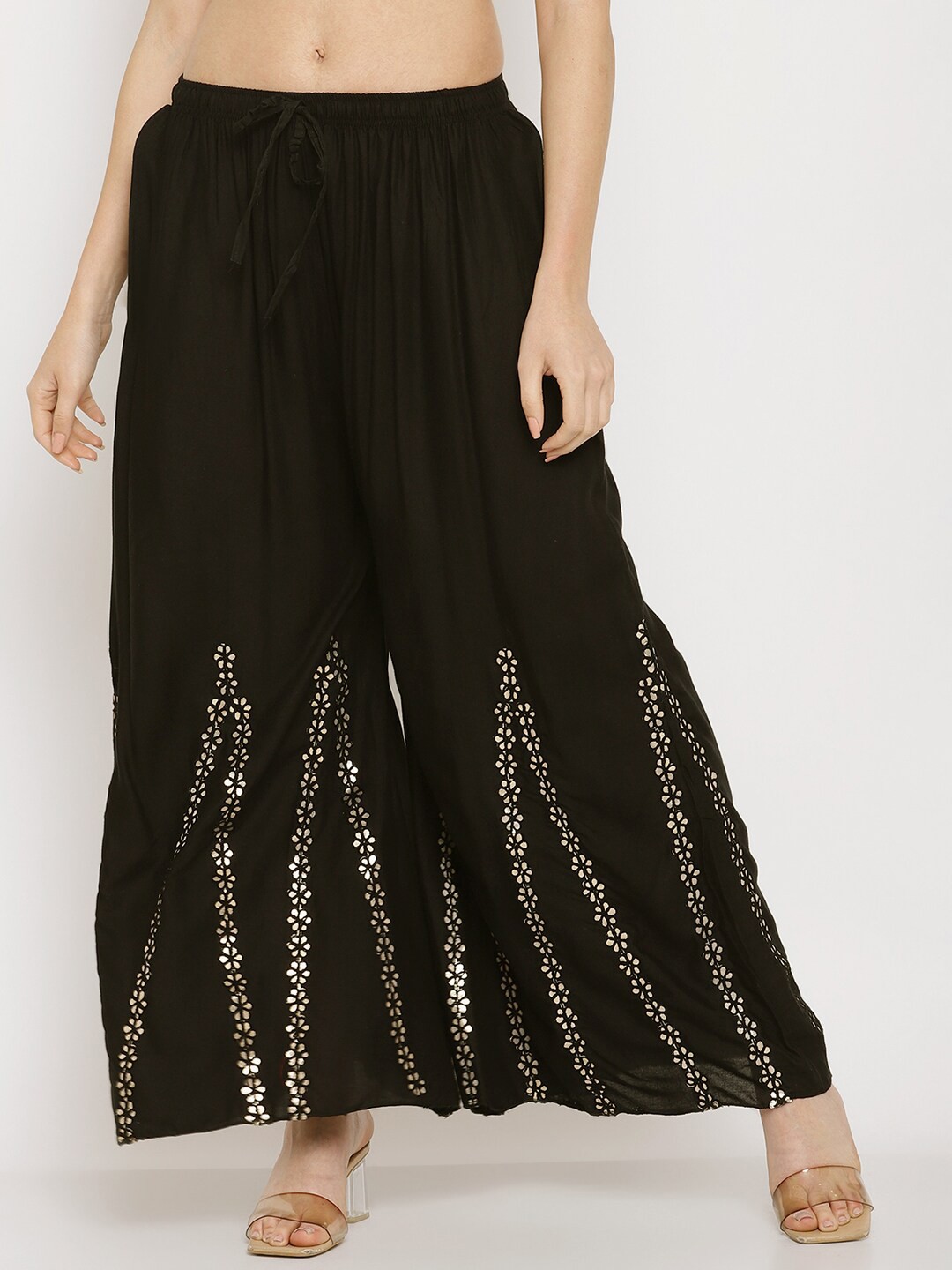 Miaz Lifestyle Women Black & Gold-Toned Ethnic Motifs Embellished Flared Knitted Palazzos
Miaz Lifestyle Women Black & Gold-Toned Ethnic Motifs Embellished Flared Knitted Palazzos