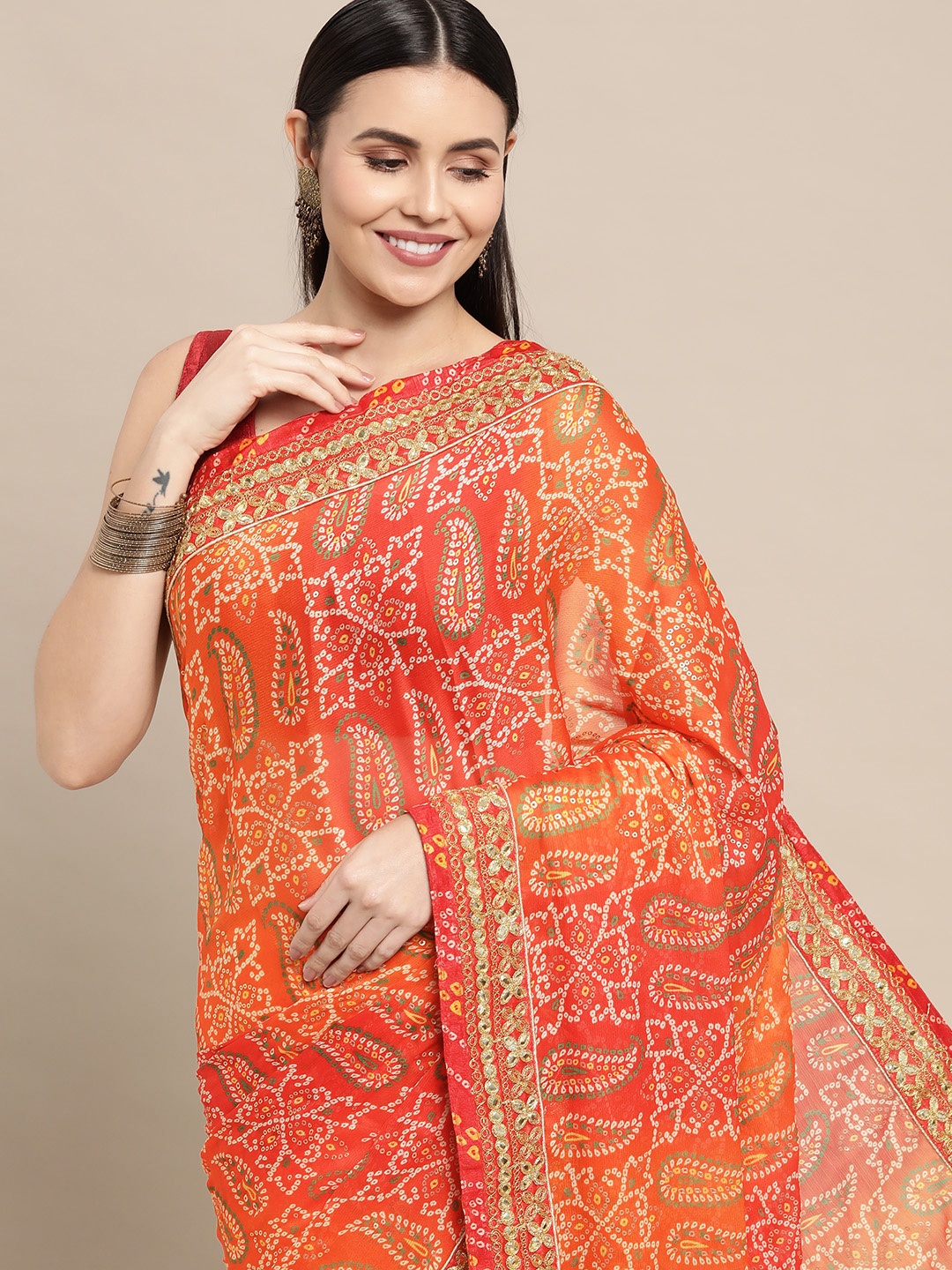 VASTRANAND Orange & Red Bandhani Printed Sequined Embroidered Saree with Blouse
VASTRANAND Orange & Red Bandhani Printed Sequined Embroidered Saree with Blouse